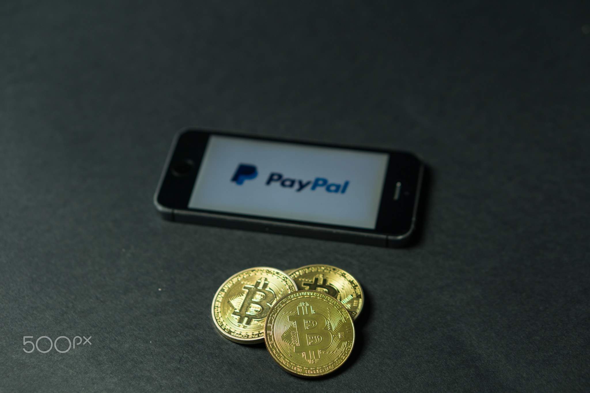 Bitcoin coin with the Paypal logo on a phone screen, Slovenia - December 23th, 2018