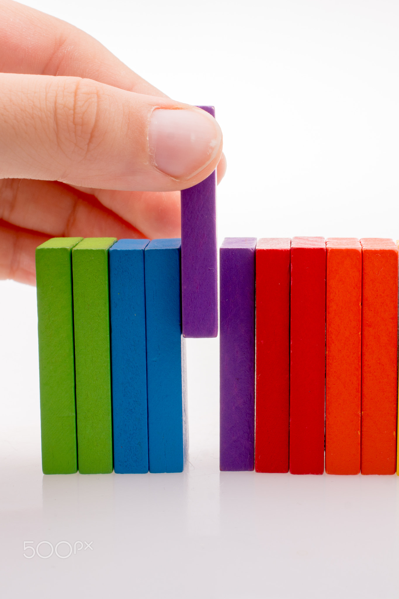 Hand holding color dominoes