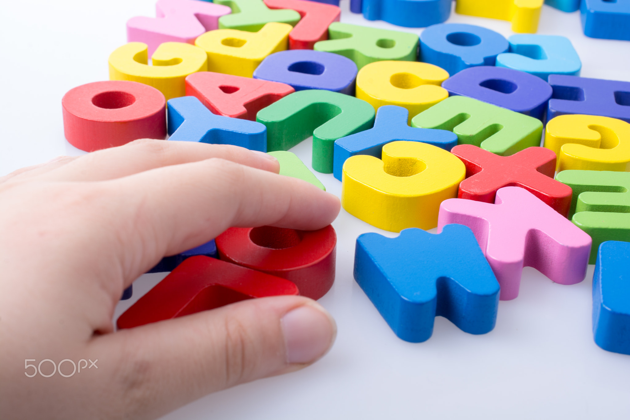 Colorful letter blocks scattered randomly on white