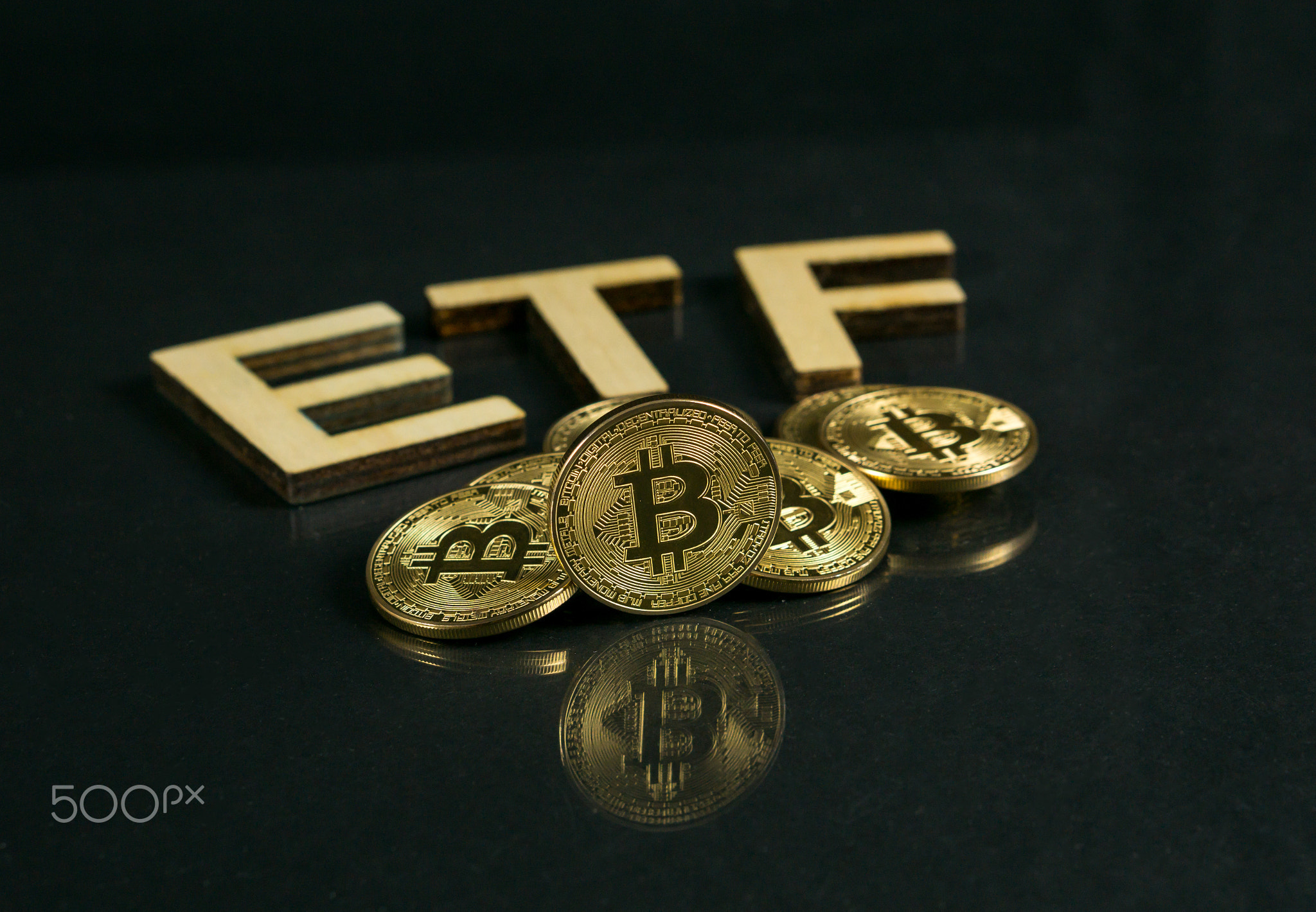 Bitcoin coin with ETF text Put on wooden floor, Concept Entering the Digital Money Fund.