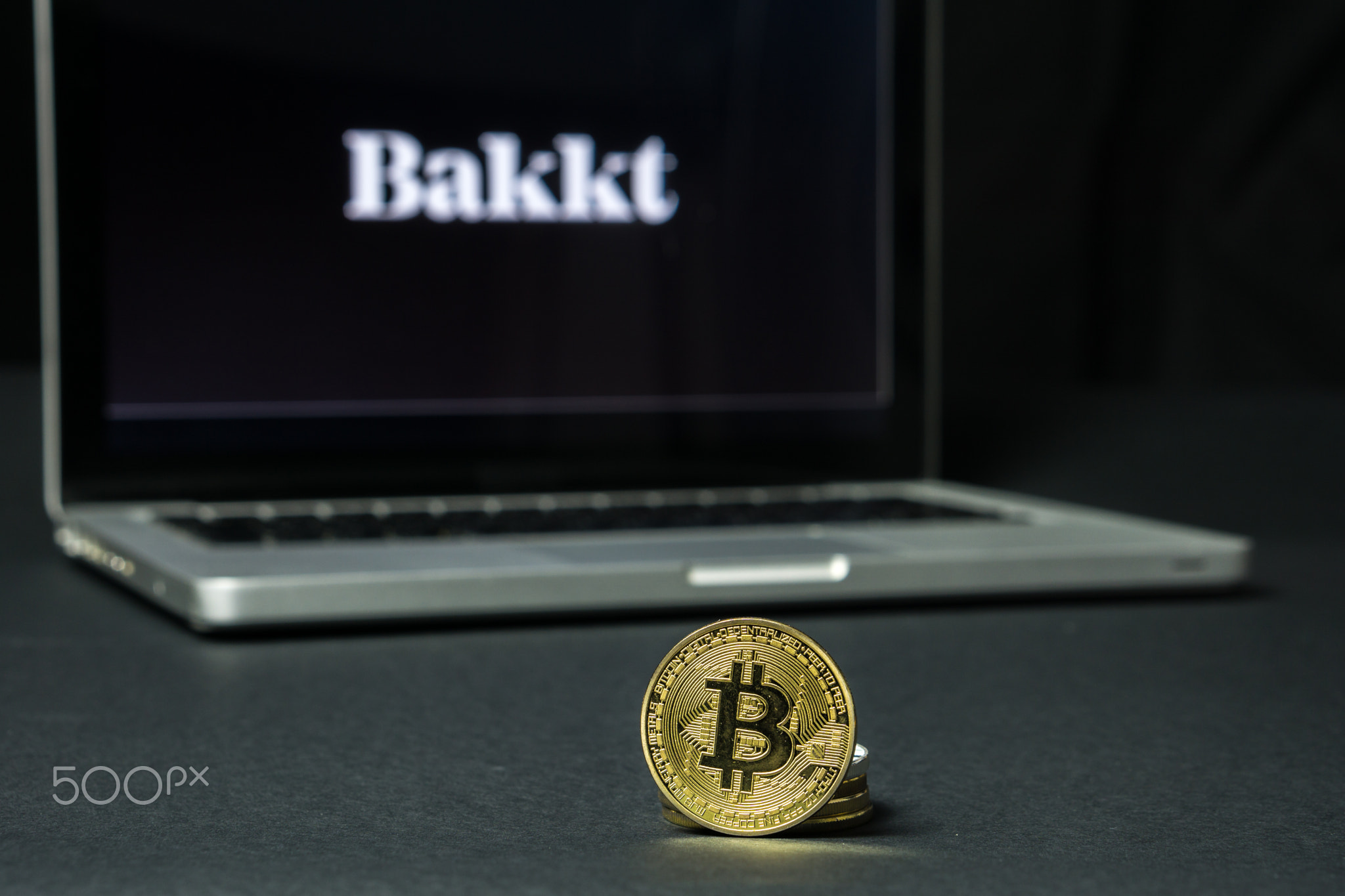 Bitcoin coin with the Bakkt logo on a laptop screen, Slovenia - December 23th, 2018