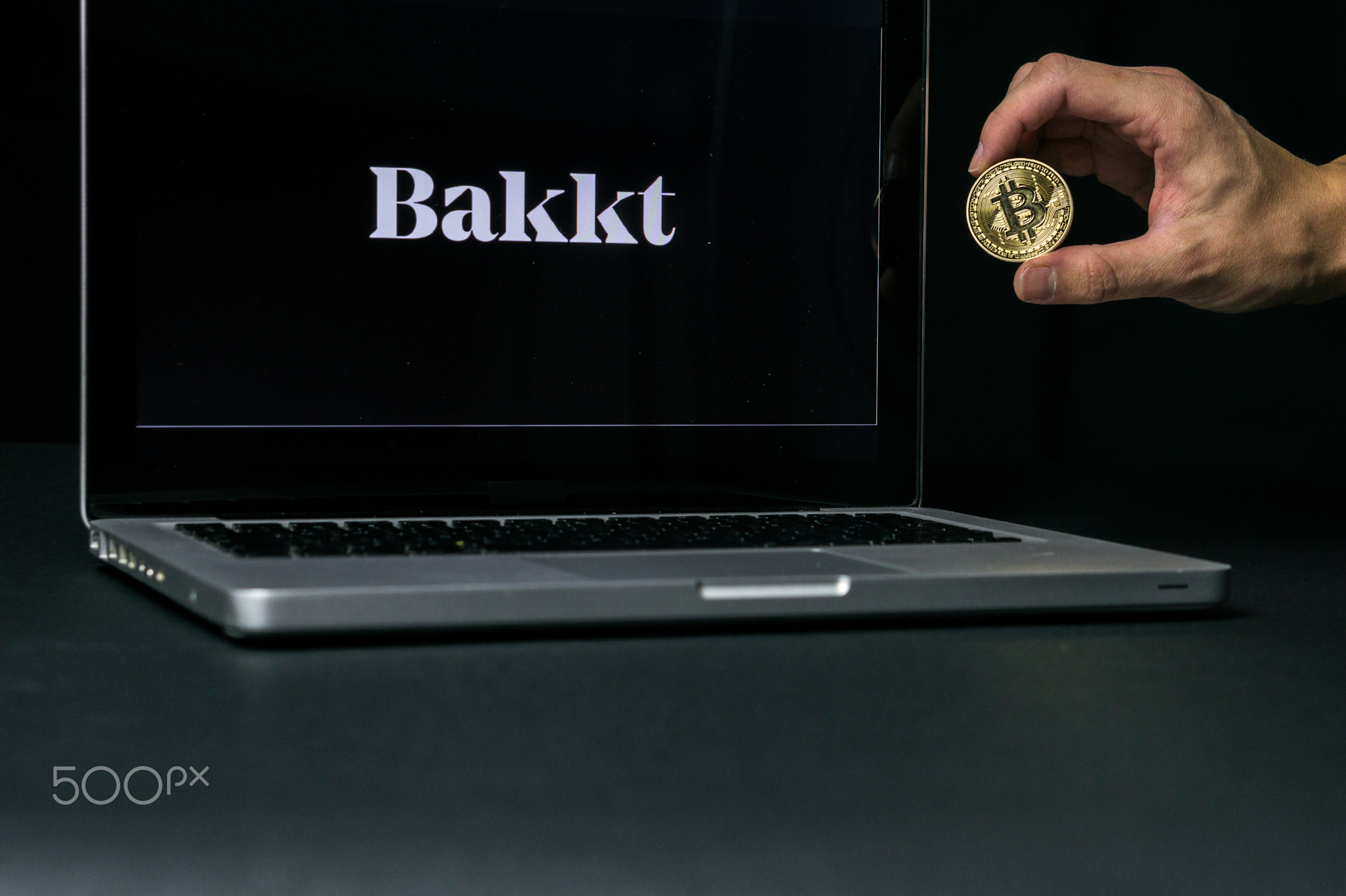 Bitcoin coin with the Bakkt logo on a laptop screen, Slovenia - December 23th, 2018