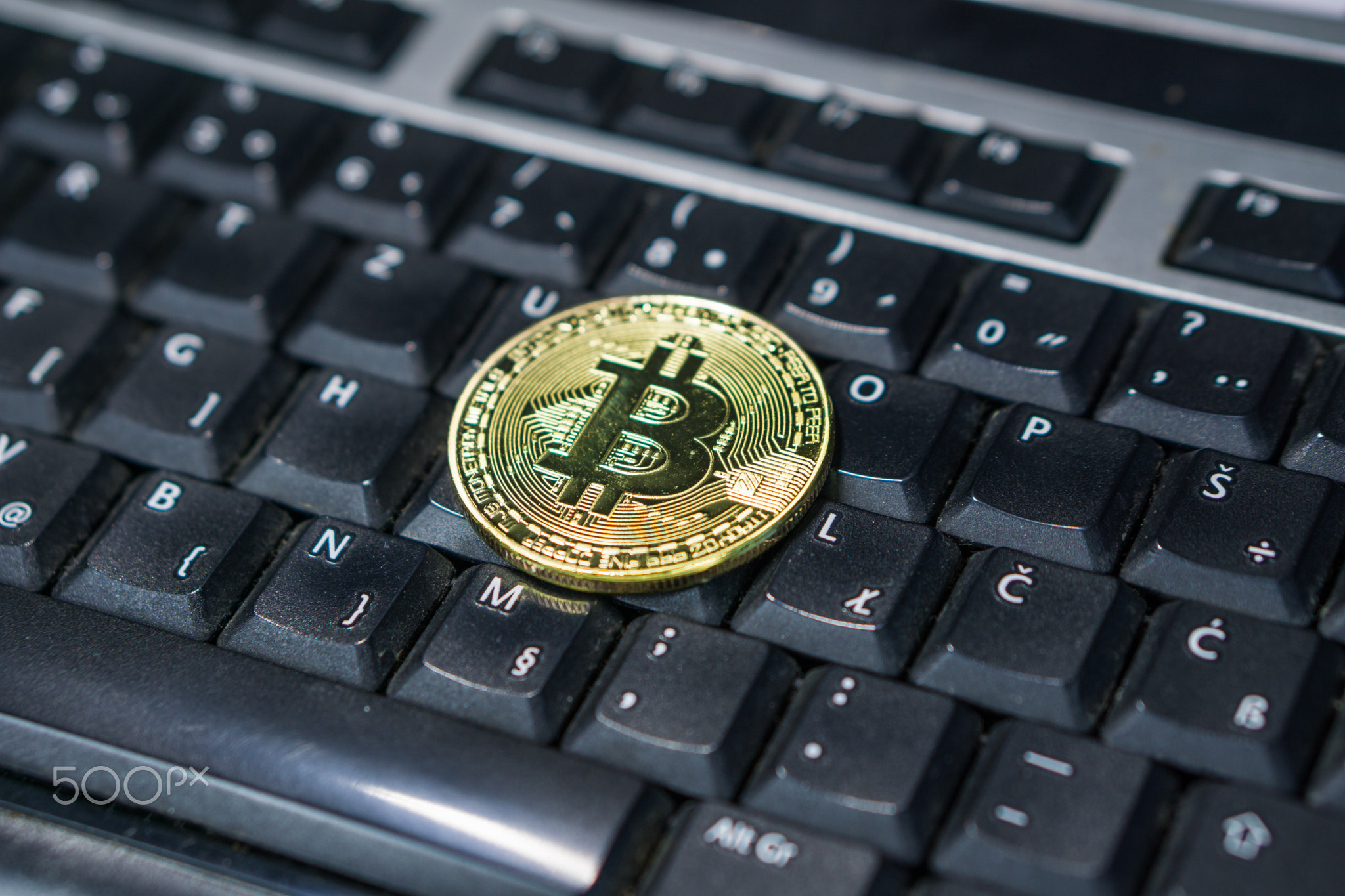 Background with bitcoin on the computer keyboard