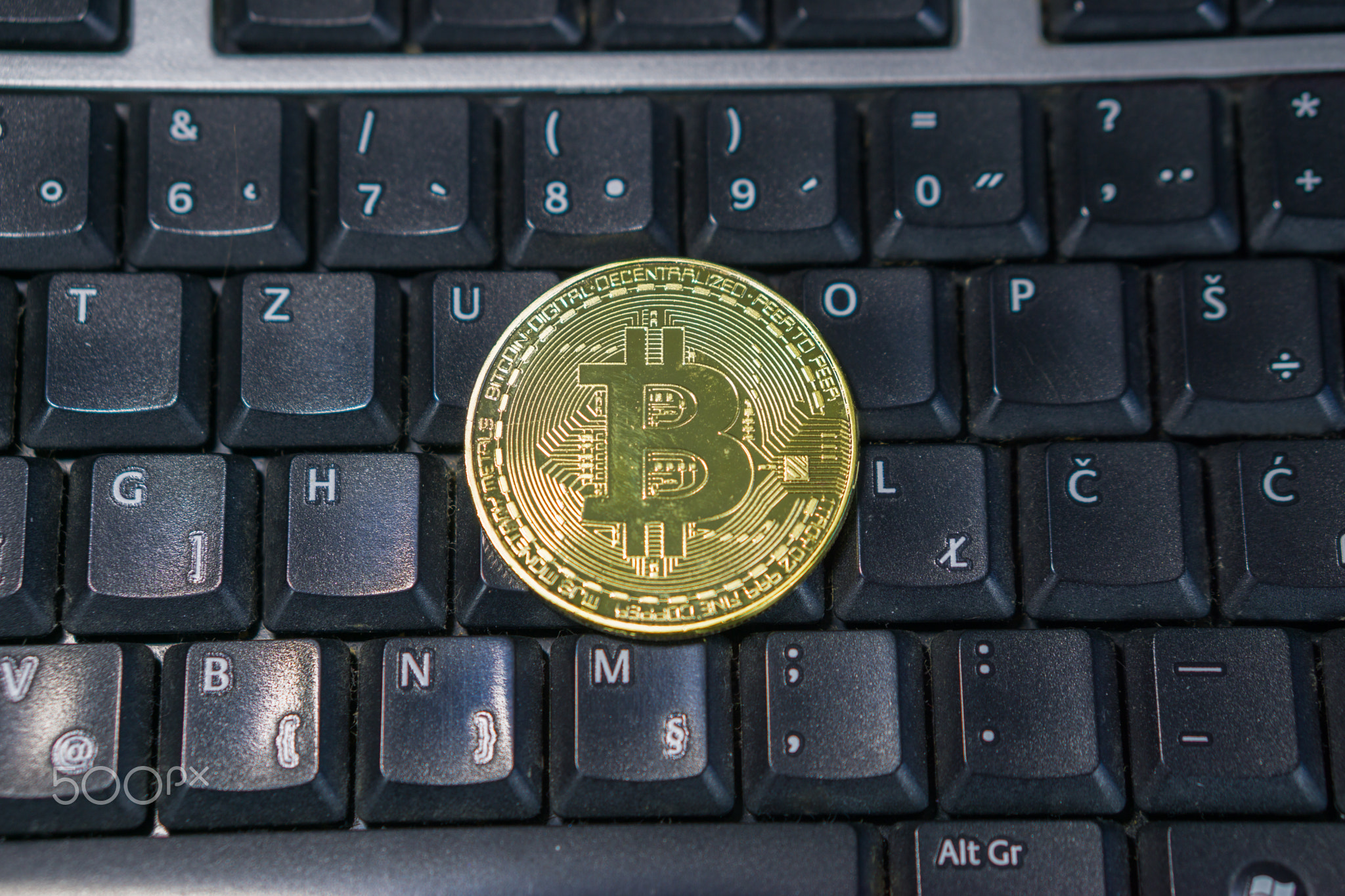 Background with bitcoin on the computer keyboard