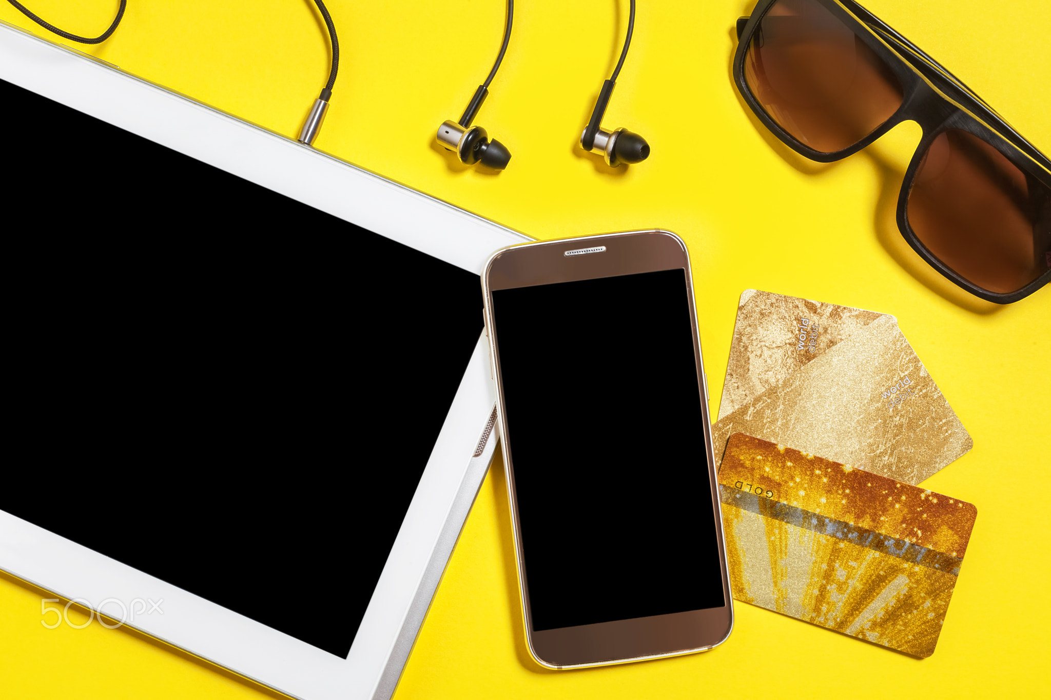 collection of modern devices on a yellow background