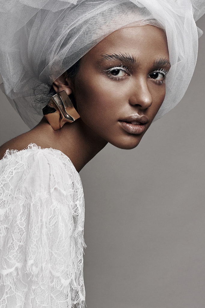 Fashion portrait of woman with white make up, in white lace dress with white veil head tie and... by Jaroslav Monchak on 500px.com