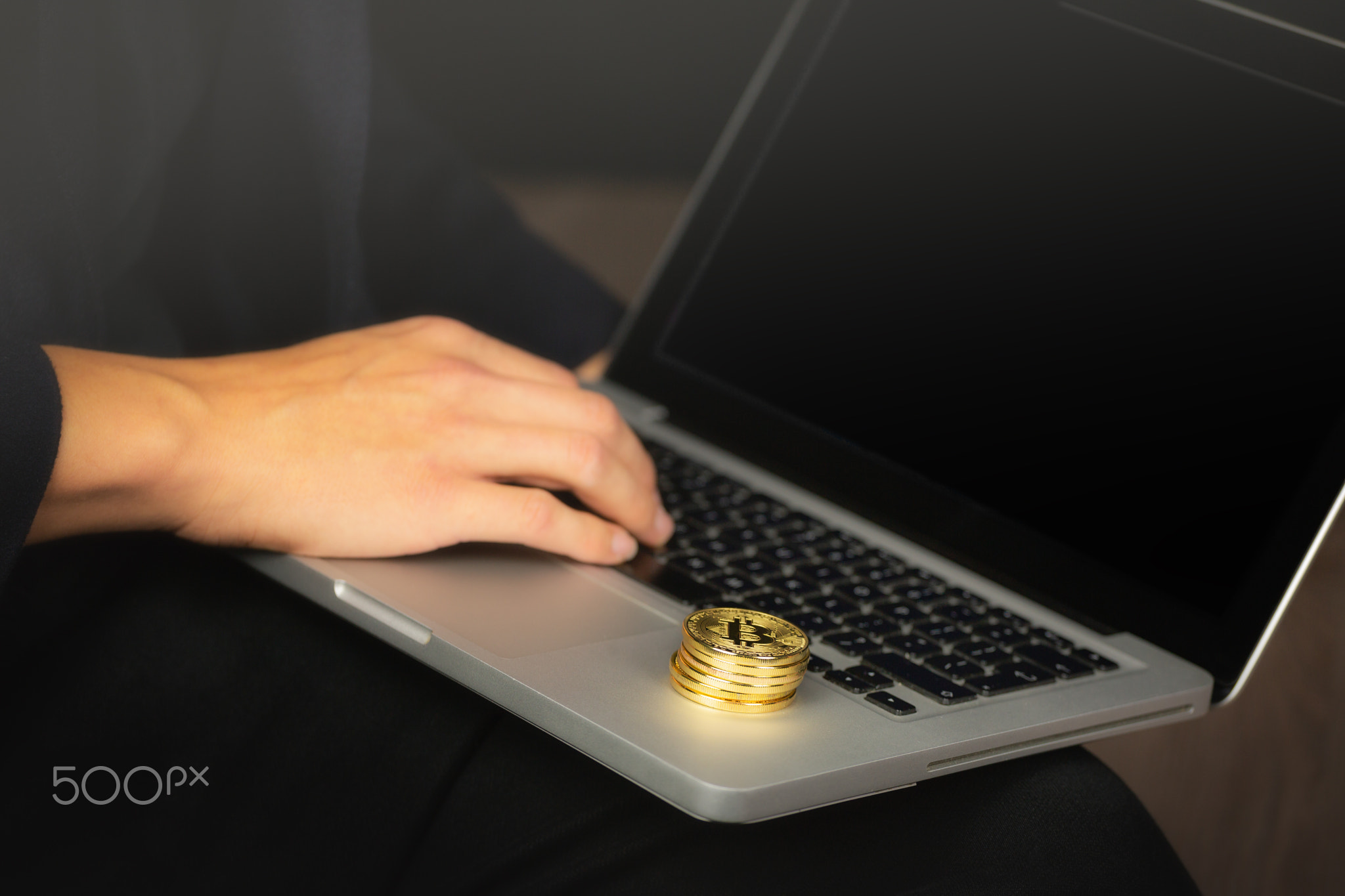 Businessman on laptop with bitcoin coins