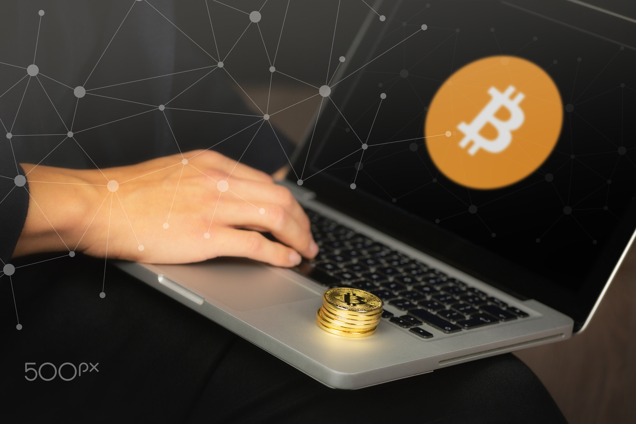 Businessman on laptop with bitcoin coins