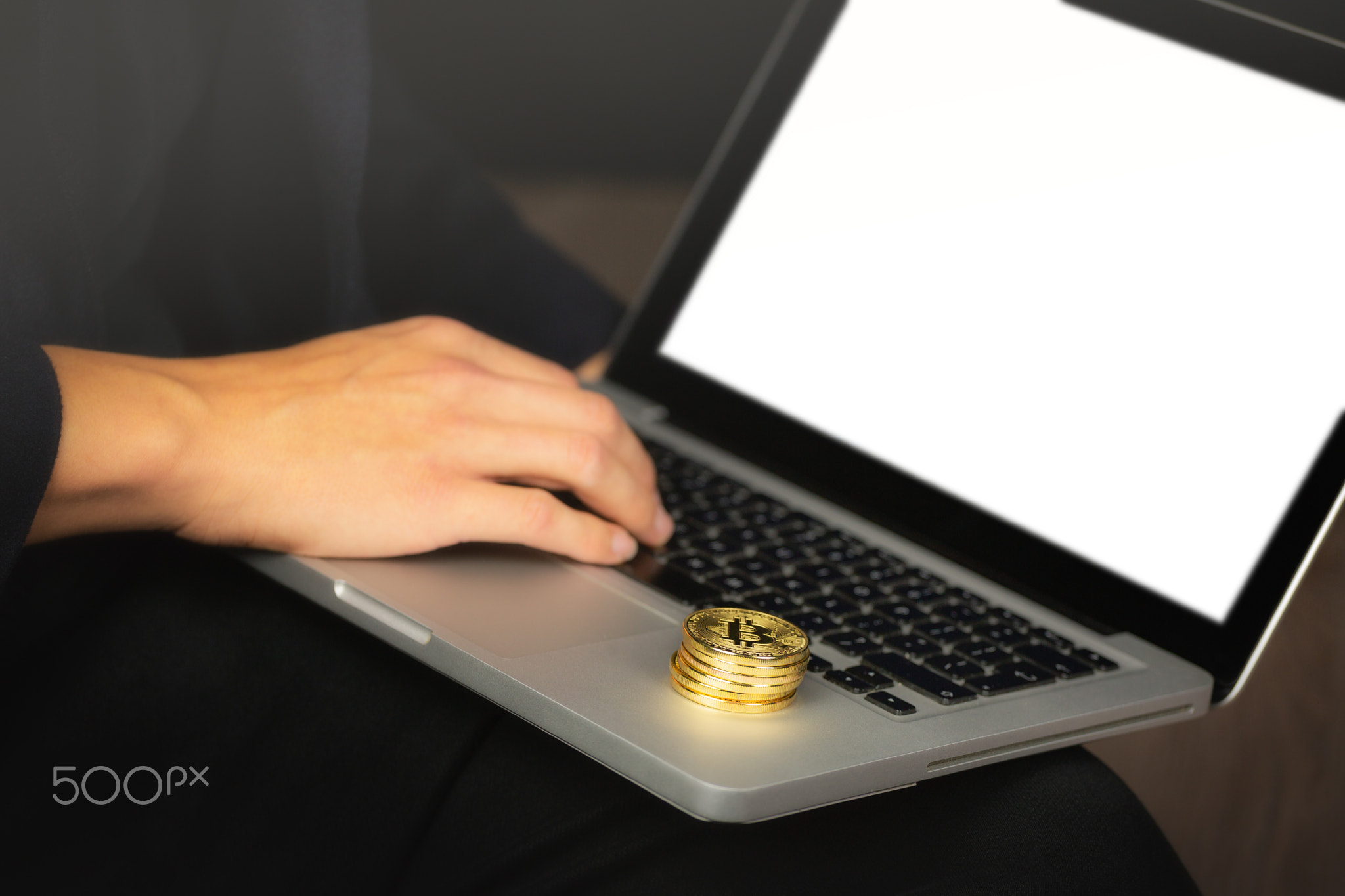 Businessman on laptop with bitcoin coins