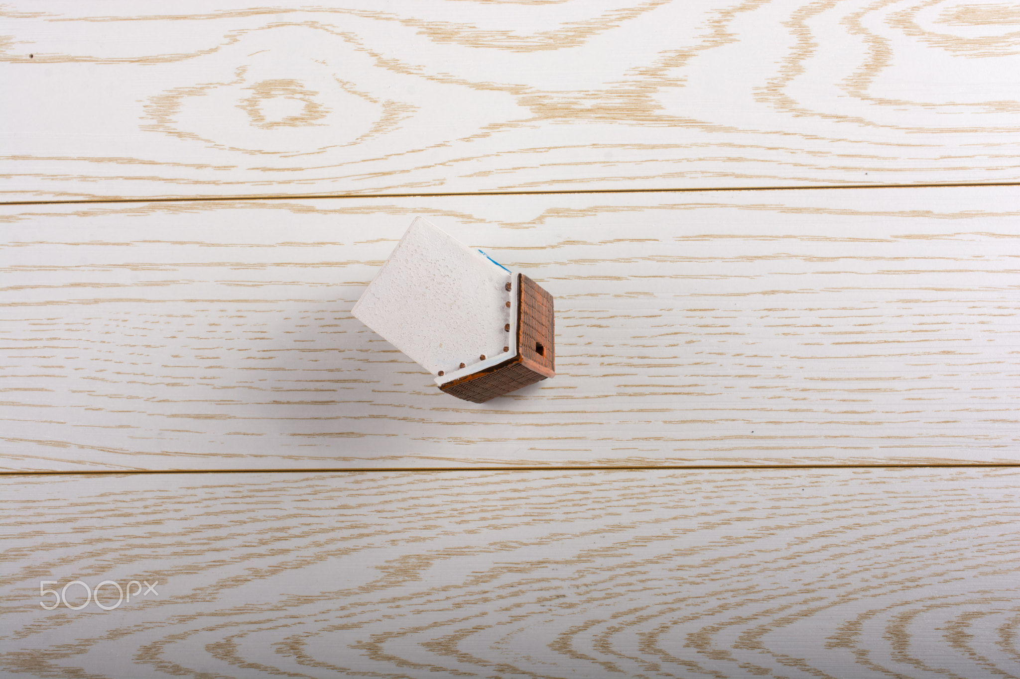 Little model house on a parquet background