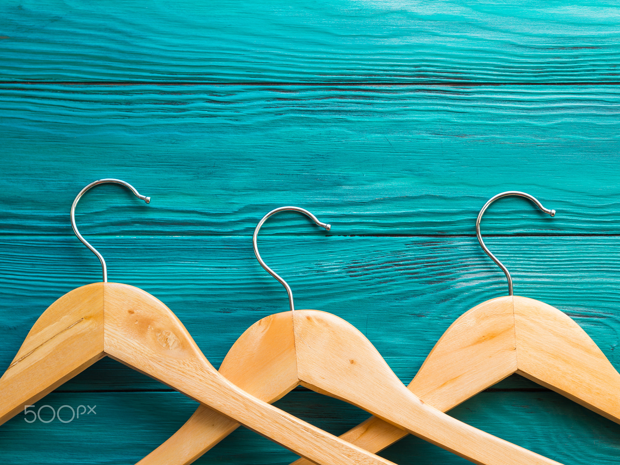 Wooden hangers on green background. Concept