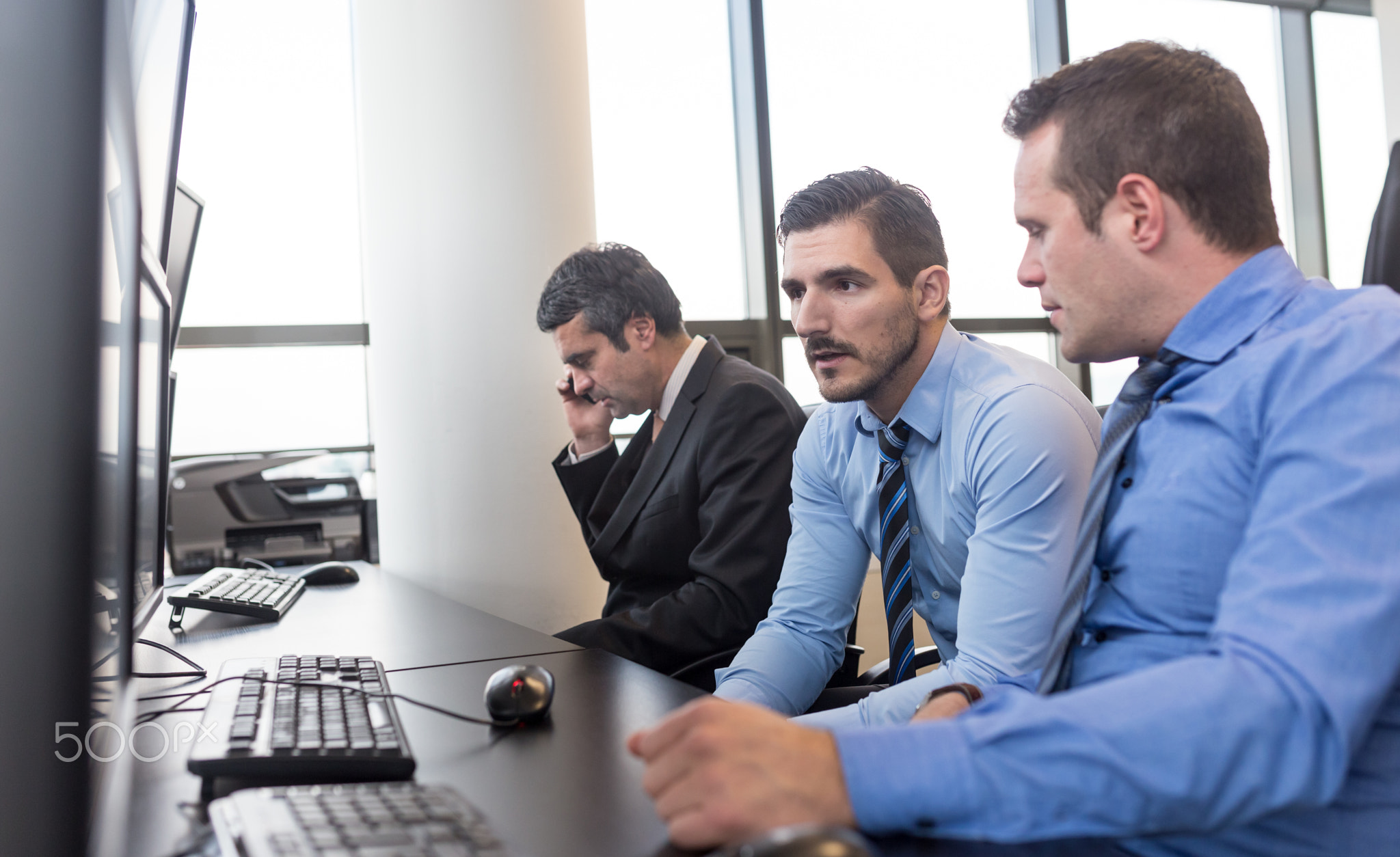 Worried stock traders brainstorming in corporate office.