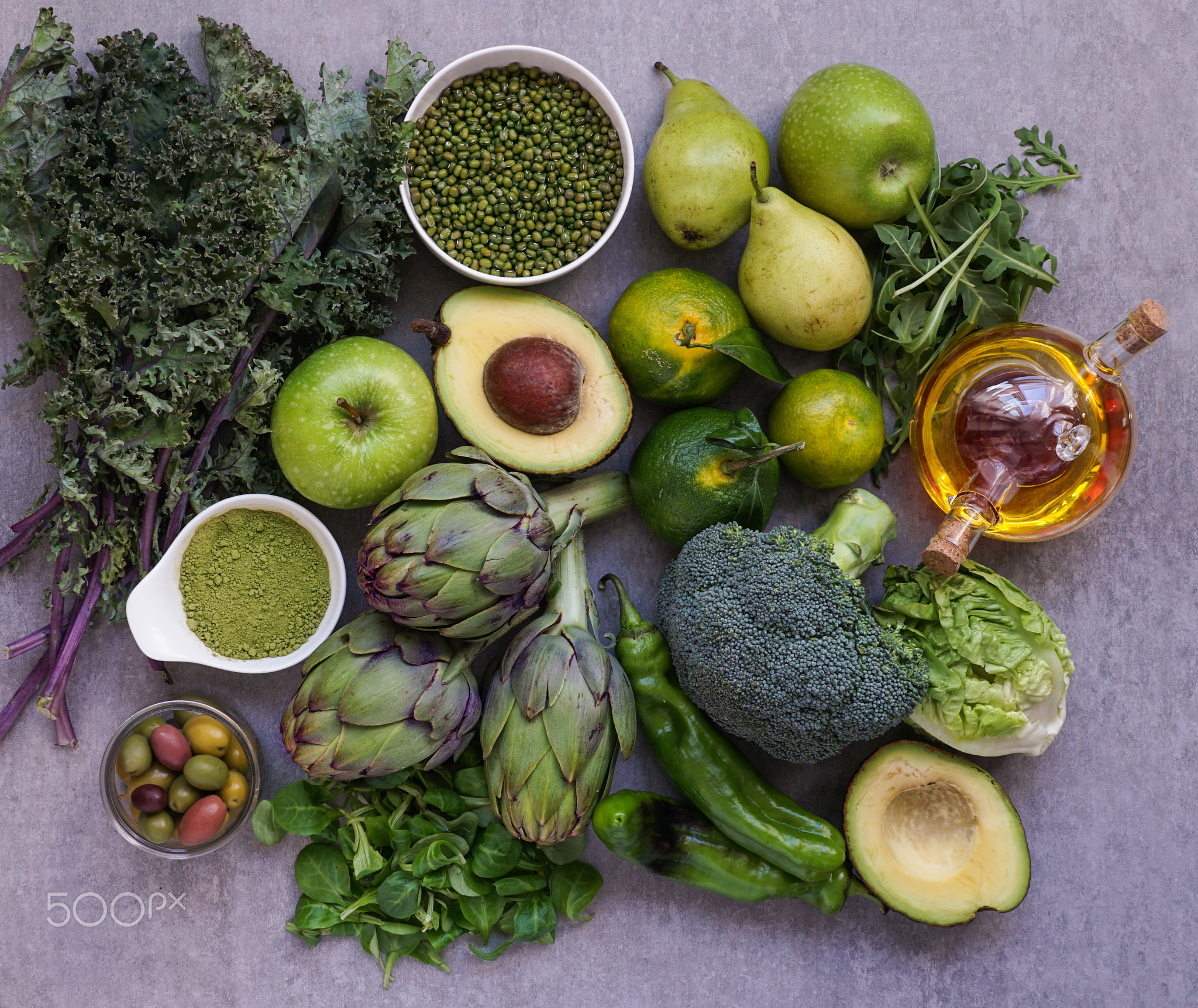 Healthy Green food selection for vegetarians: avocado, apples, broccoli, artichokes, tangerines,...