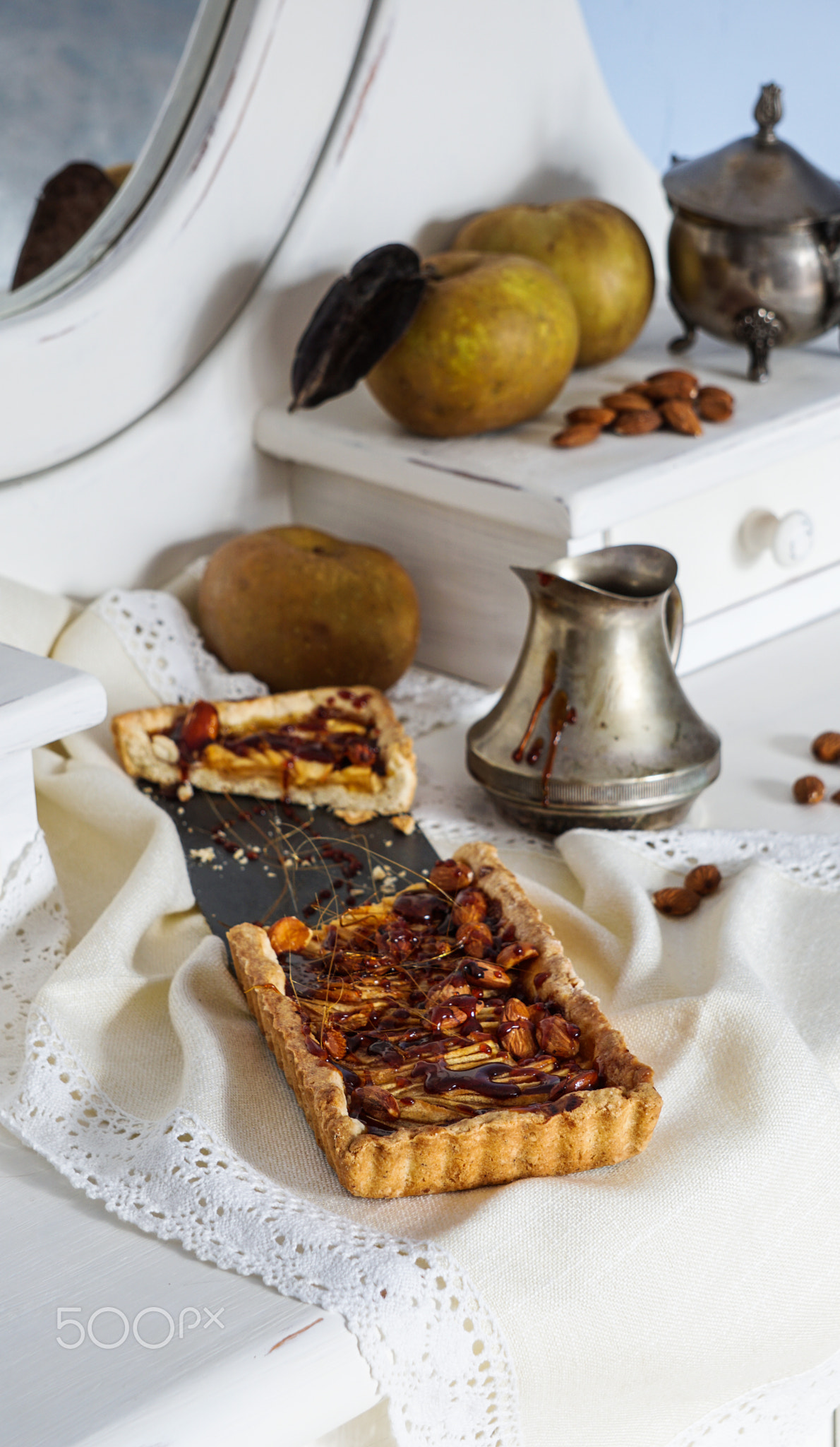 caramel apple tart on the white wooden buffet, grey rennet apples