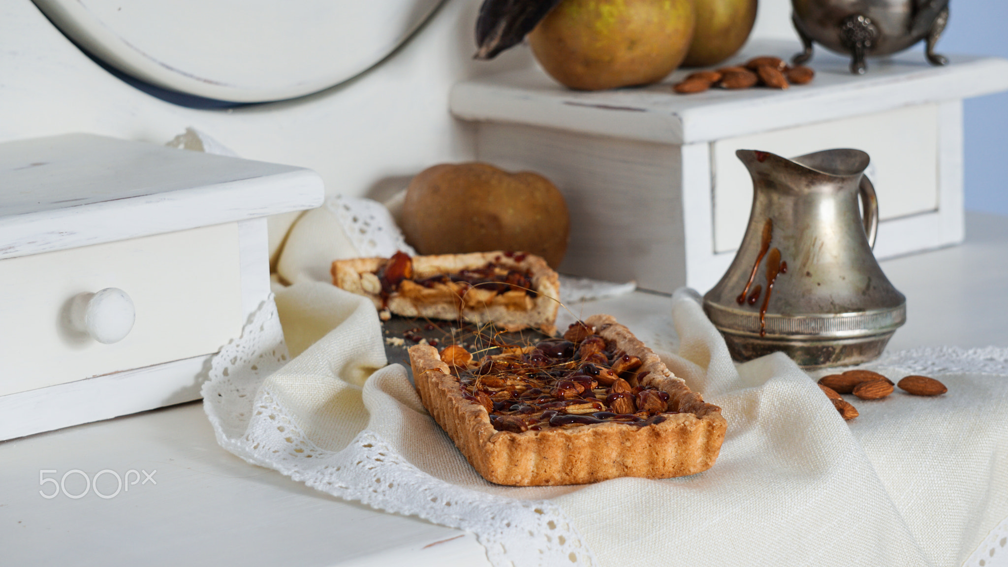 caramel apple tart on the white wooden buffet, grey rennet apples