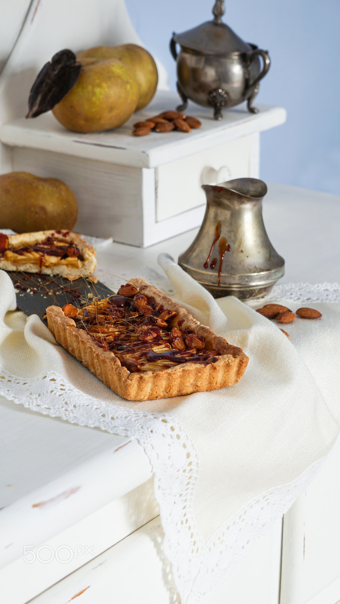 caramel apple tart on the white wooden buffet, grey rennet apples