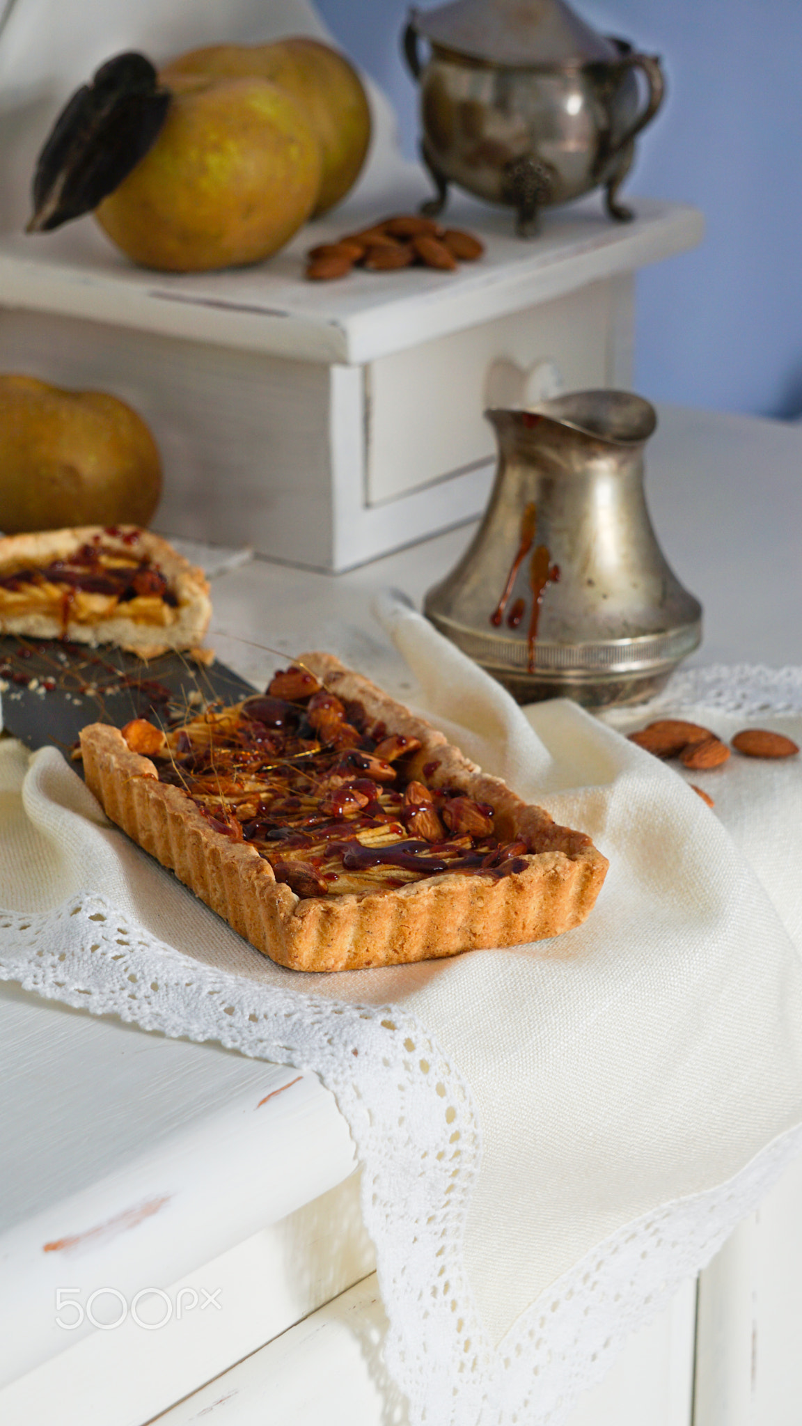 caramel apple tart on the white wooden buffet, grey rennet apples