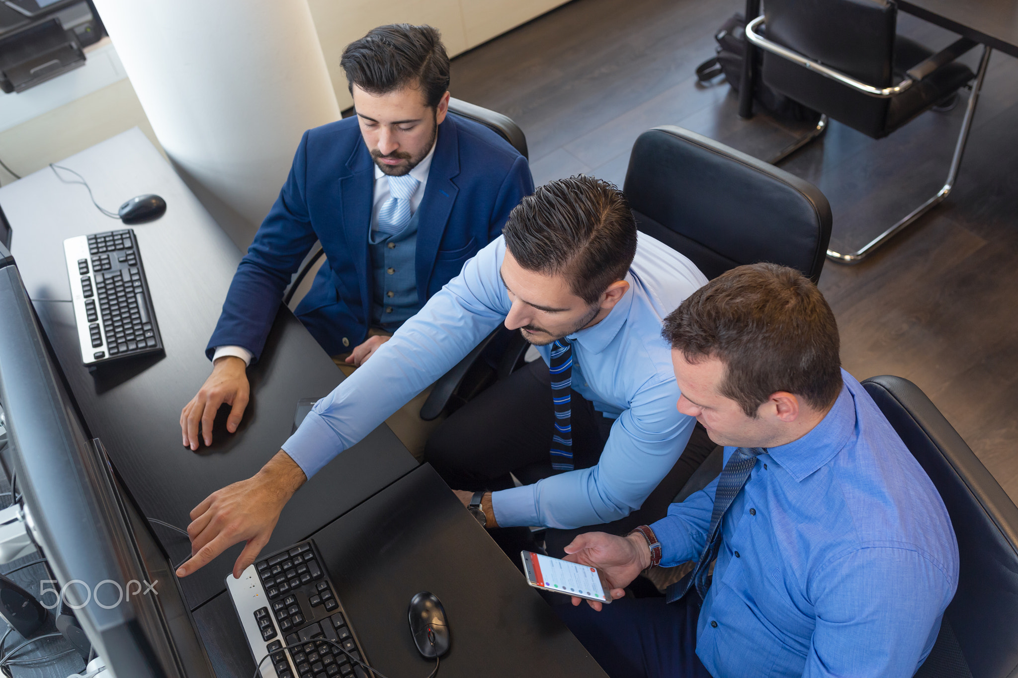 Business team analyzing trade data on computer in corporate trading office.