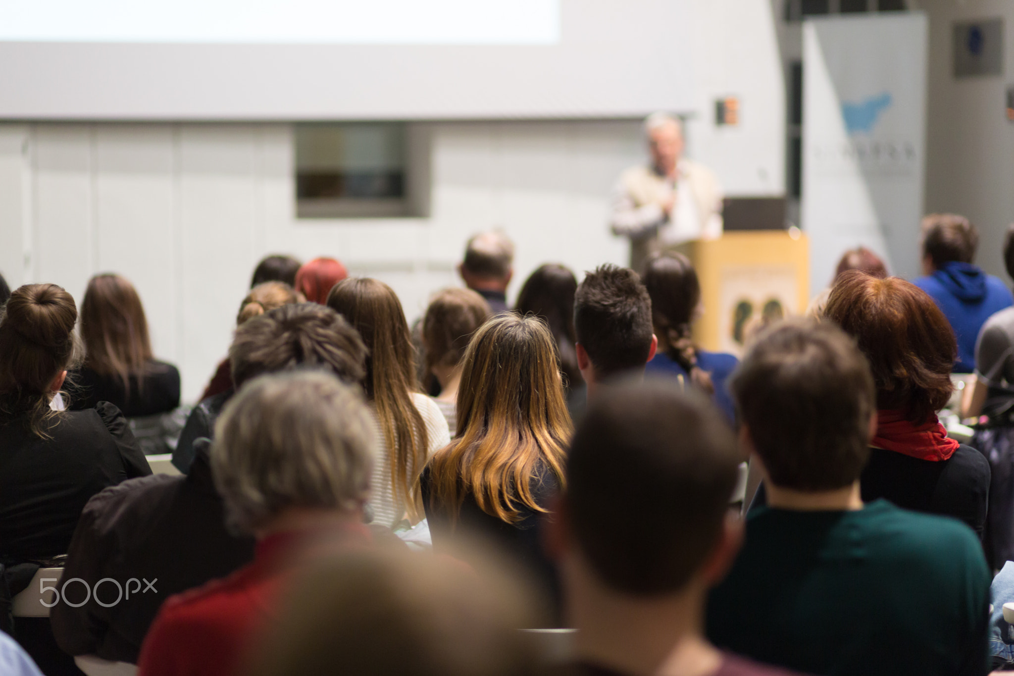 Man giving presentation in lecture hall at university.
