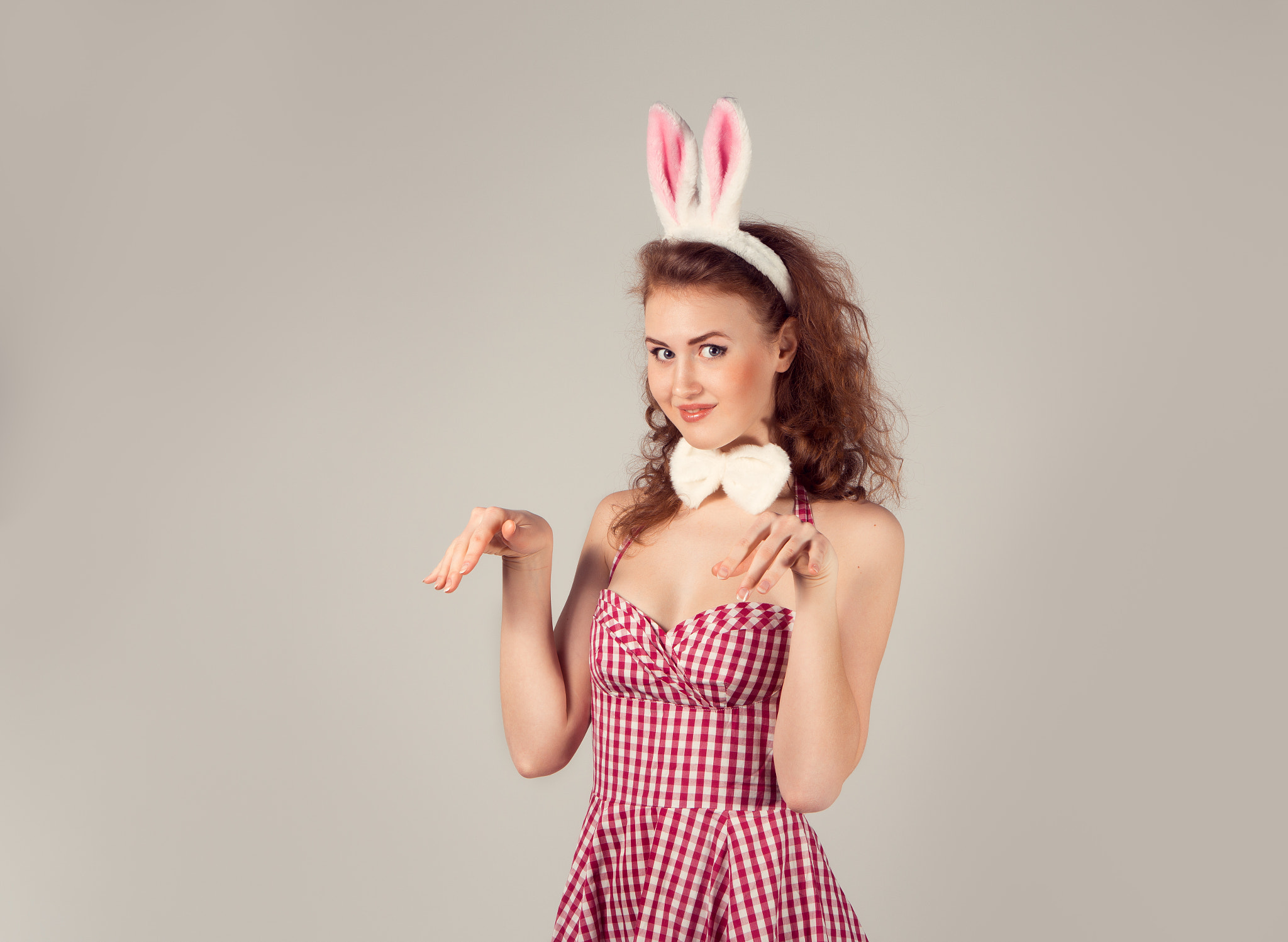 sexy girl wearing easter bunny costume with eggs in basket