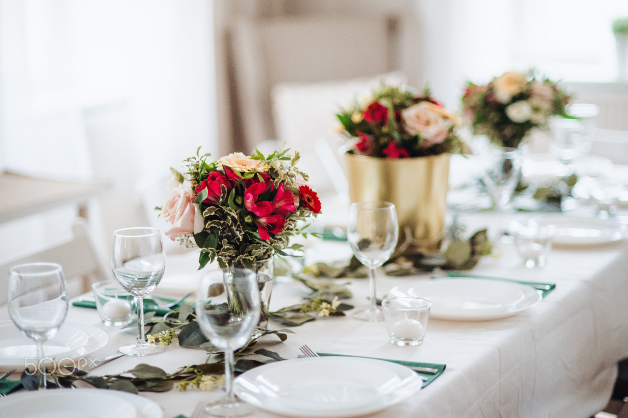 Table set for a meal indoors in a room on a party, a wedding or family celebration.