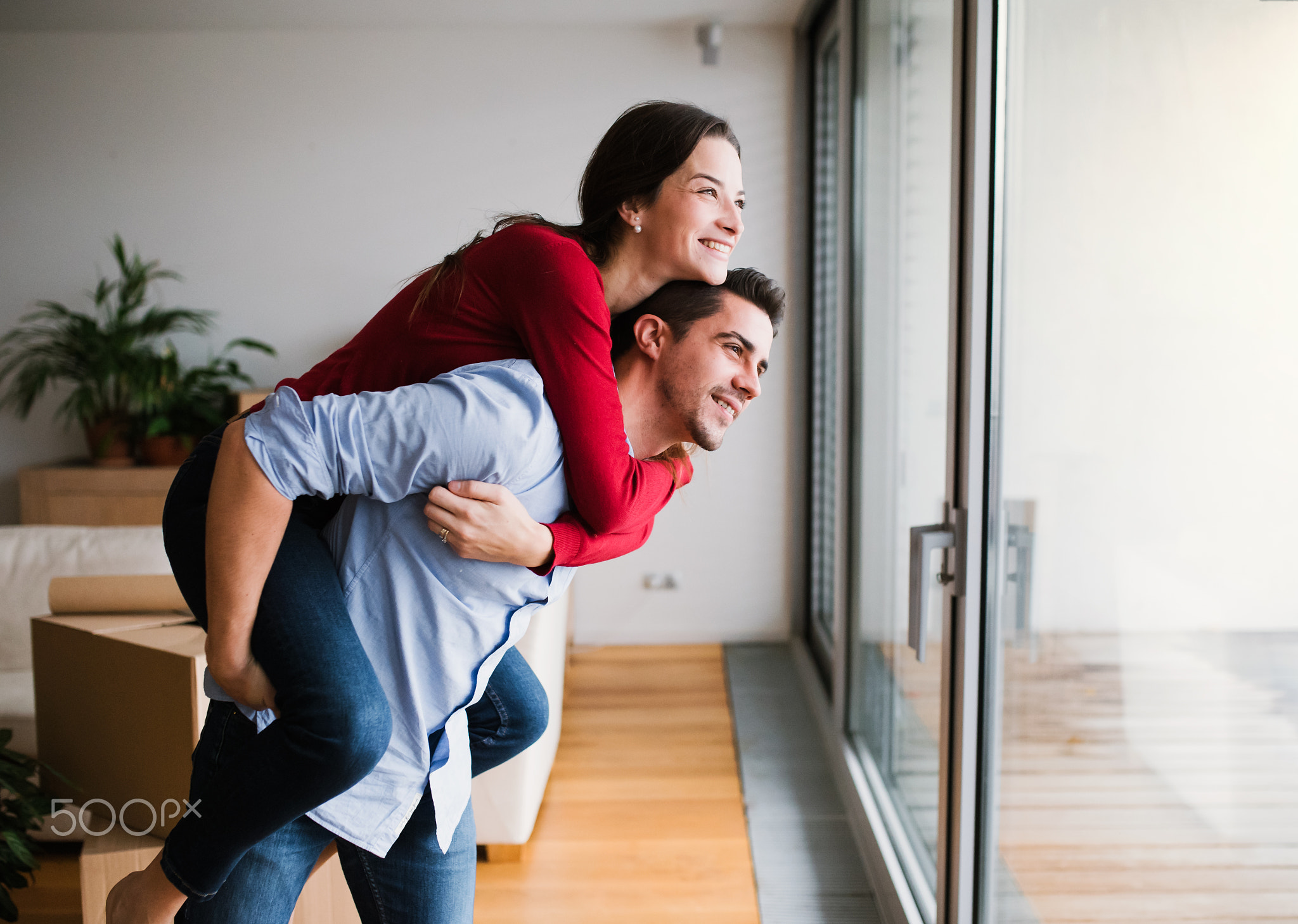 Young couple moving in a new home, having fun.