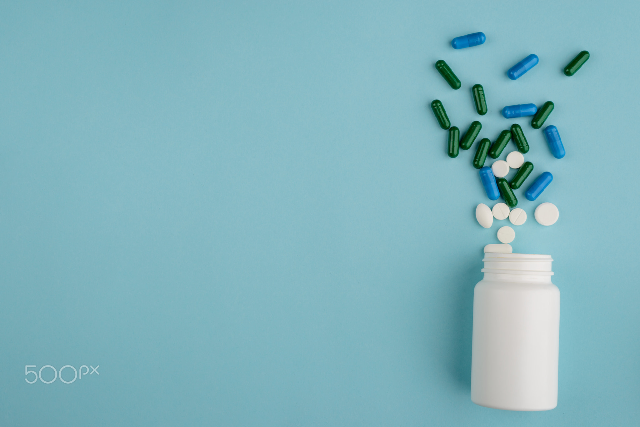 Plastic bottle and spilled pills
