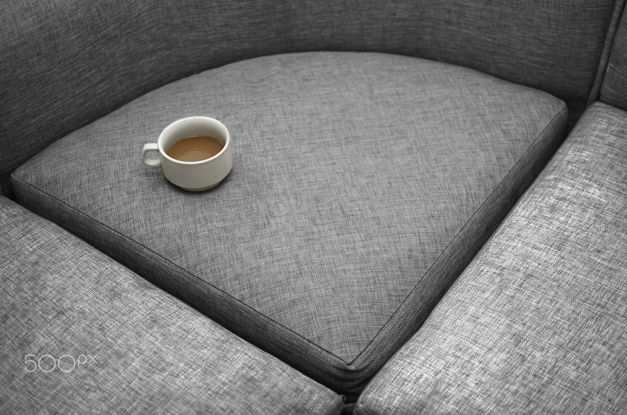 white Cup with coffee on grey surface