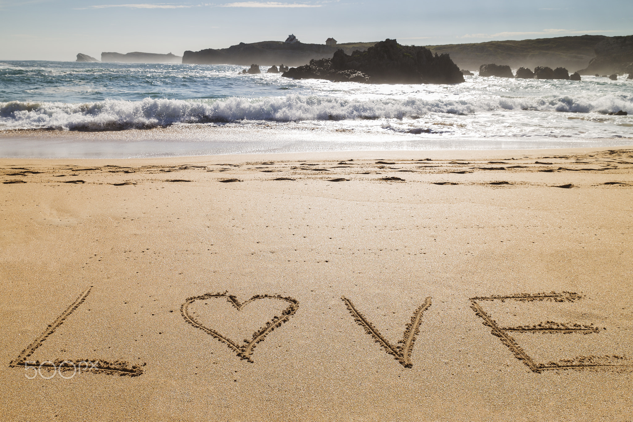 word love written in the sand of a beautiful beach