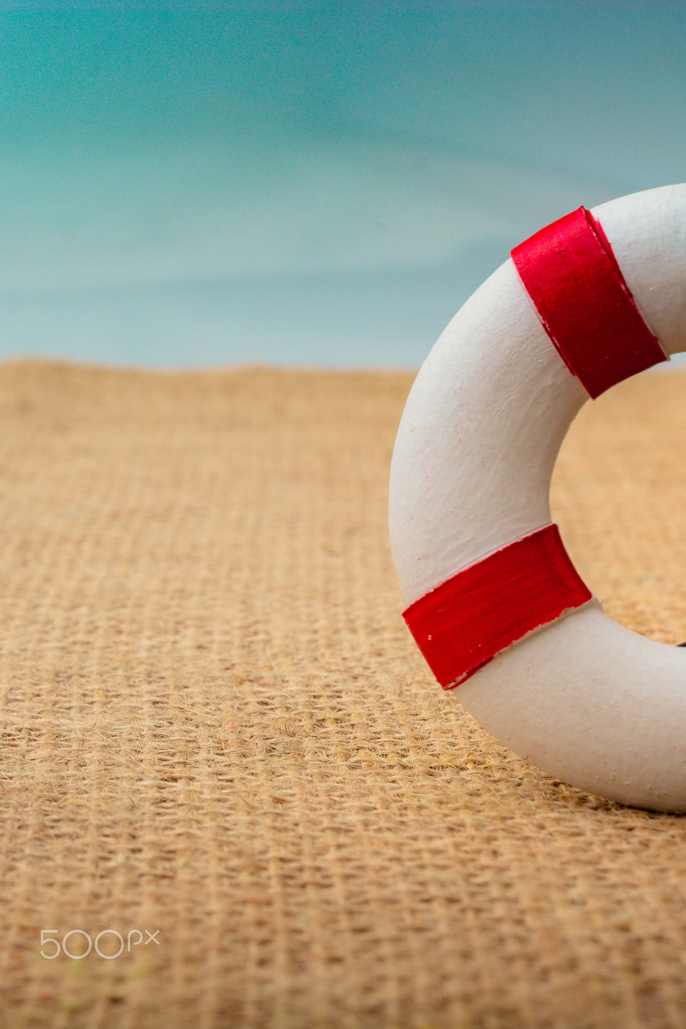 Man figurine led by an arrow to Life preserver