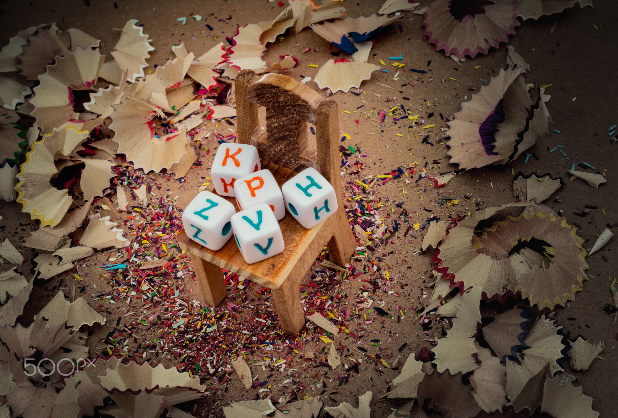 Letter cubes on chair in pencil trash