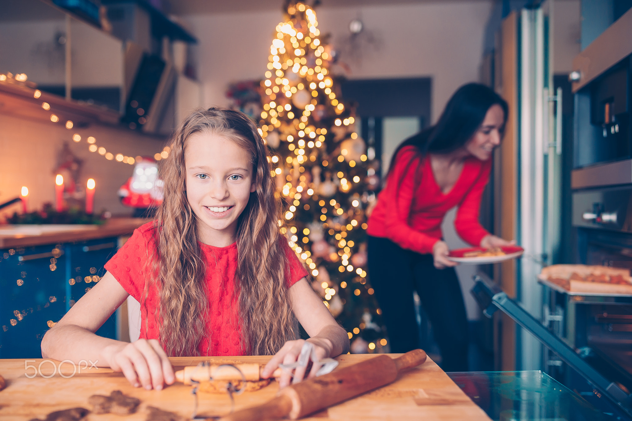 Adorable little girl baking Christmas gingerbread cookies