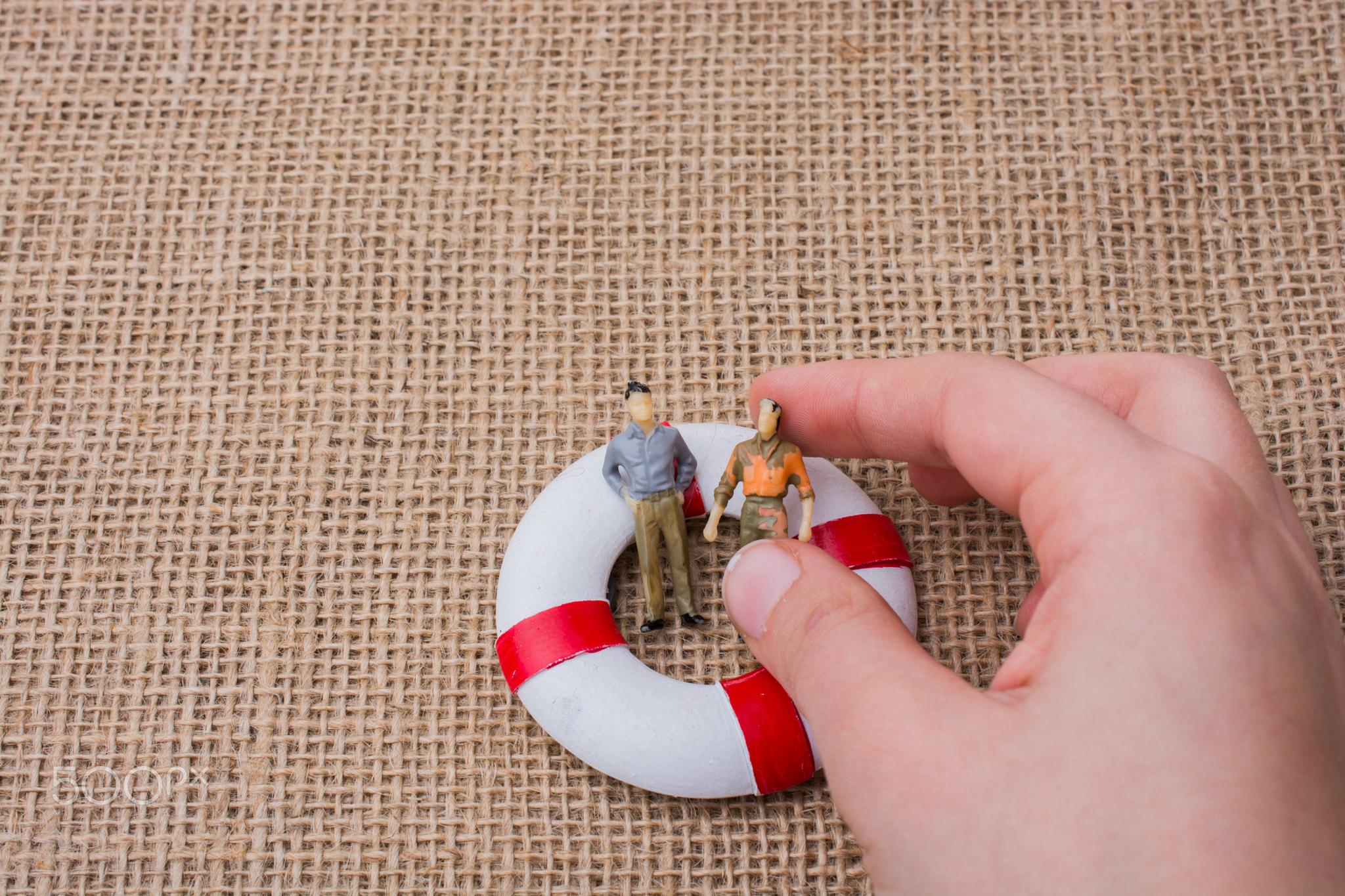 Little figurine men in a life preserver