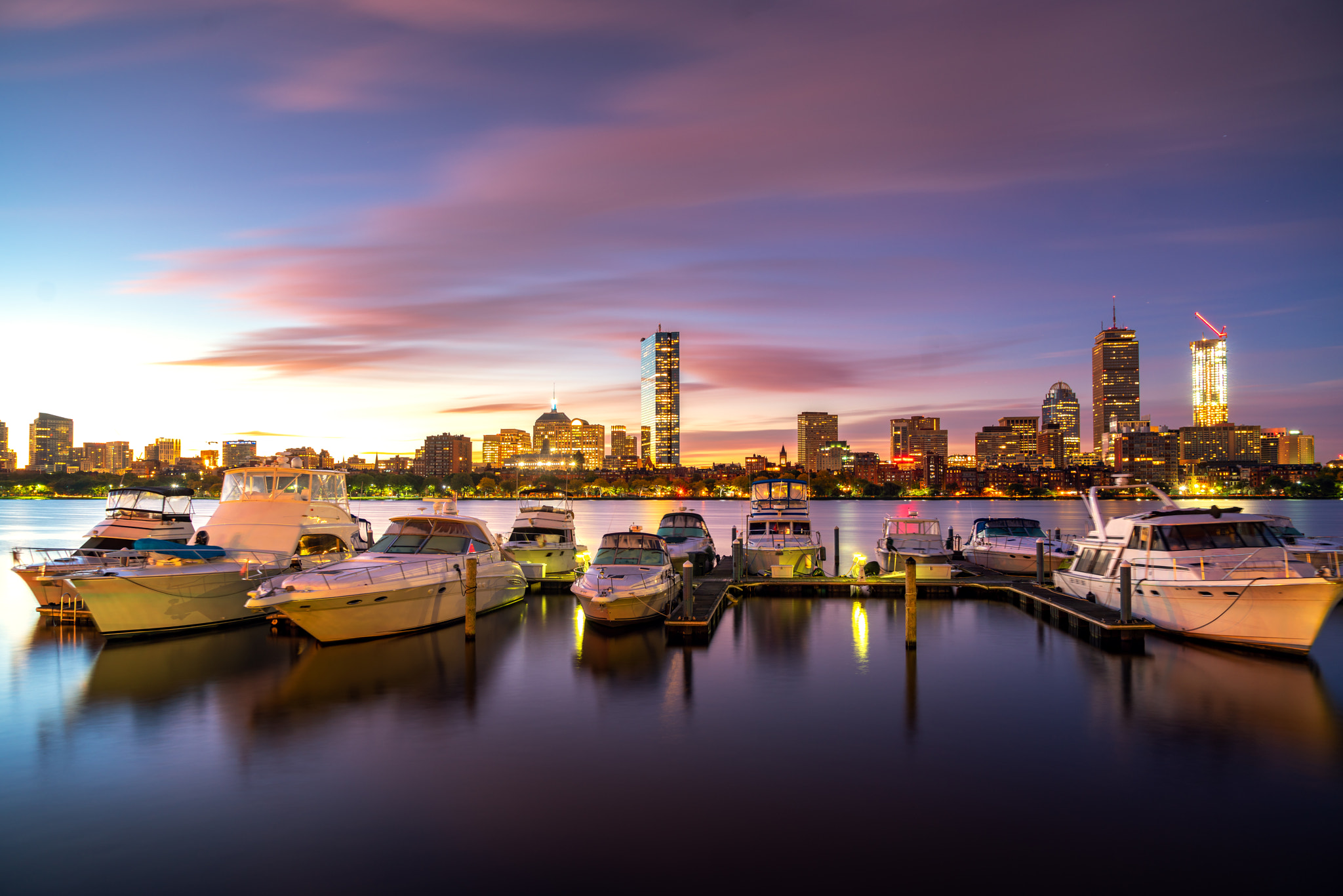 Sunrise over Boston city with boat and harbor
