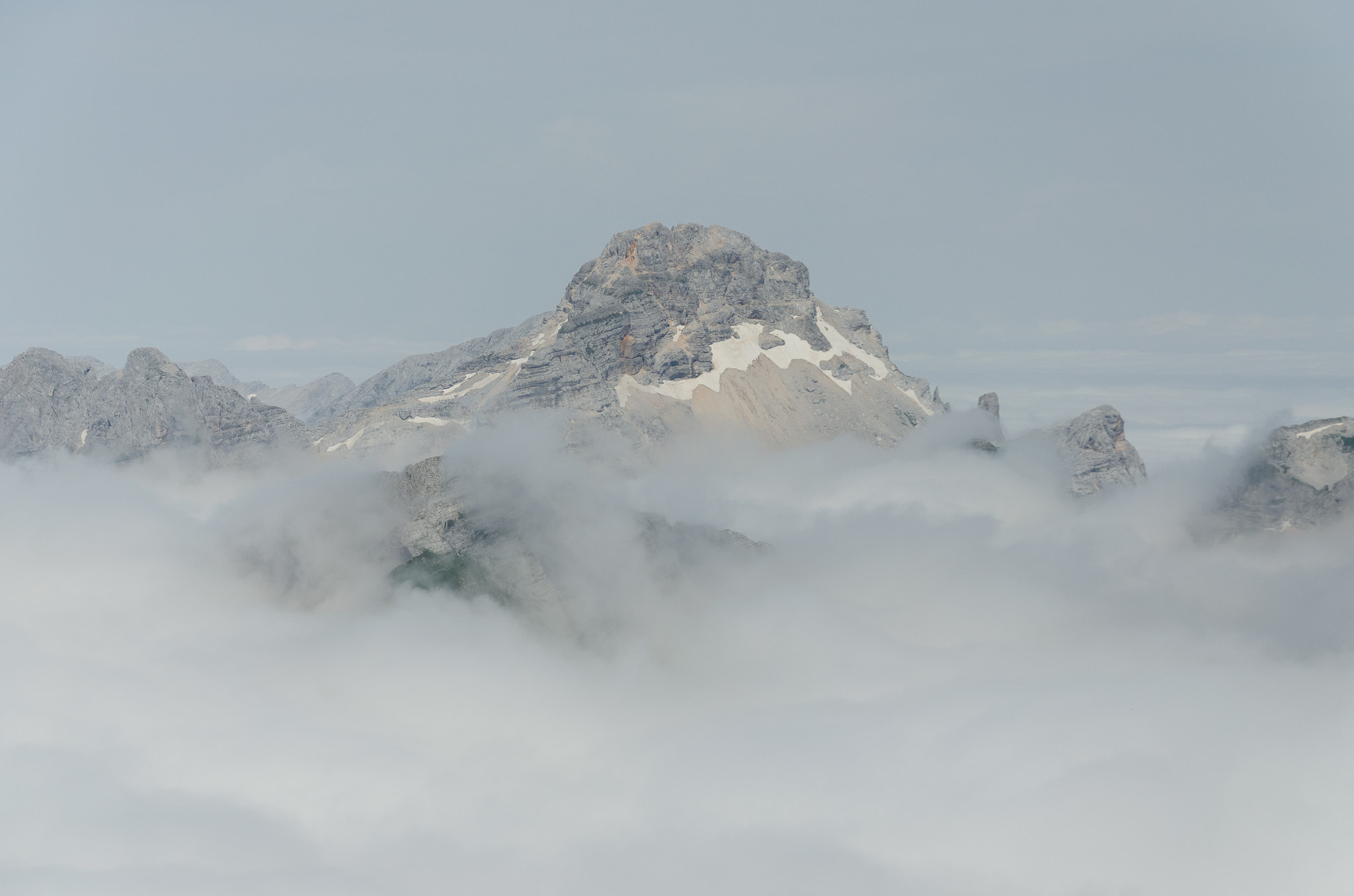 Mangart floating above the clouds in Triglav national park