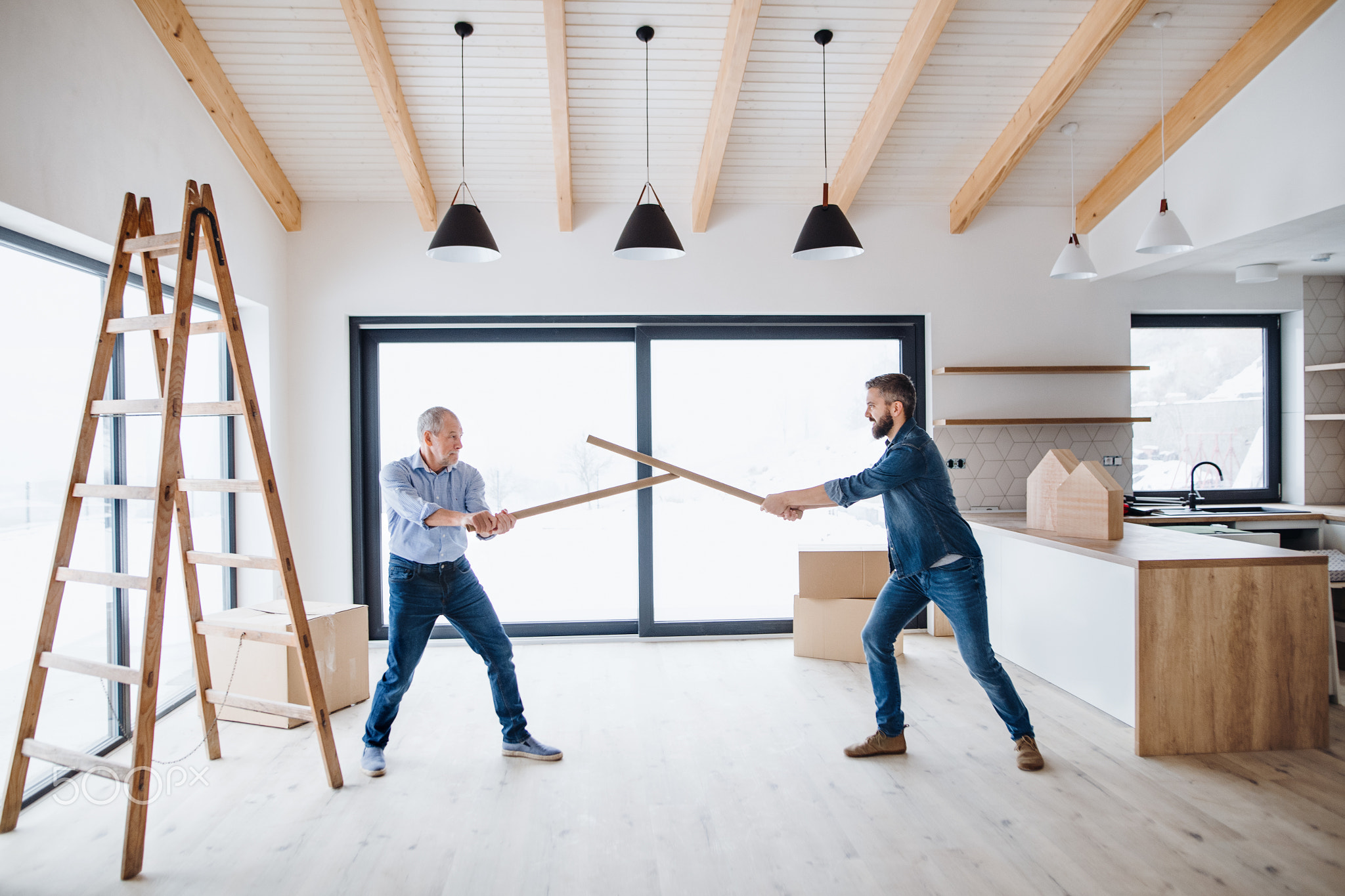 Two men having fun when furnishing new house, a new home concept.