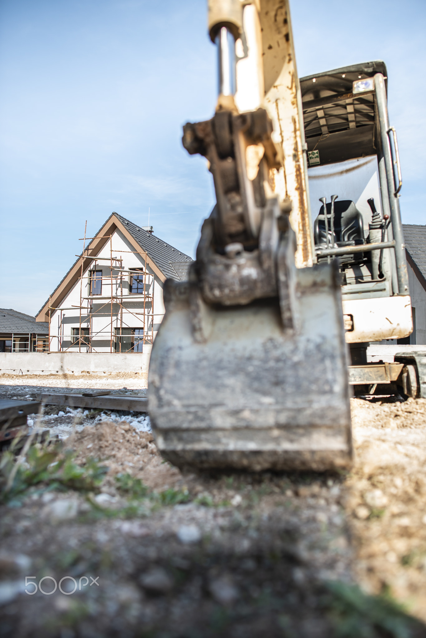 Excavator and new built houses