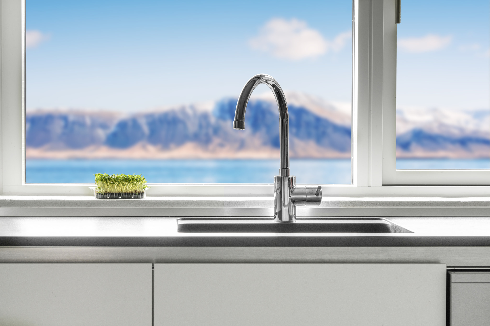 Kitchen sink by a window with a view
