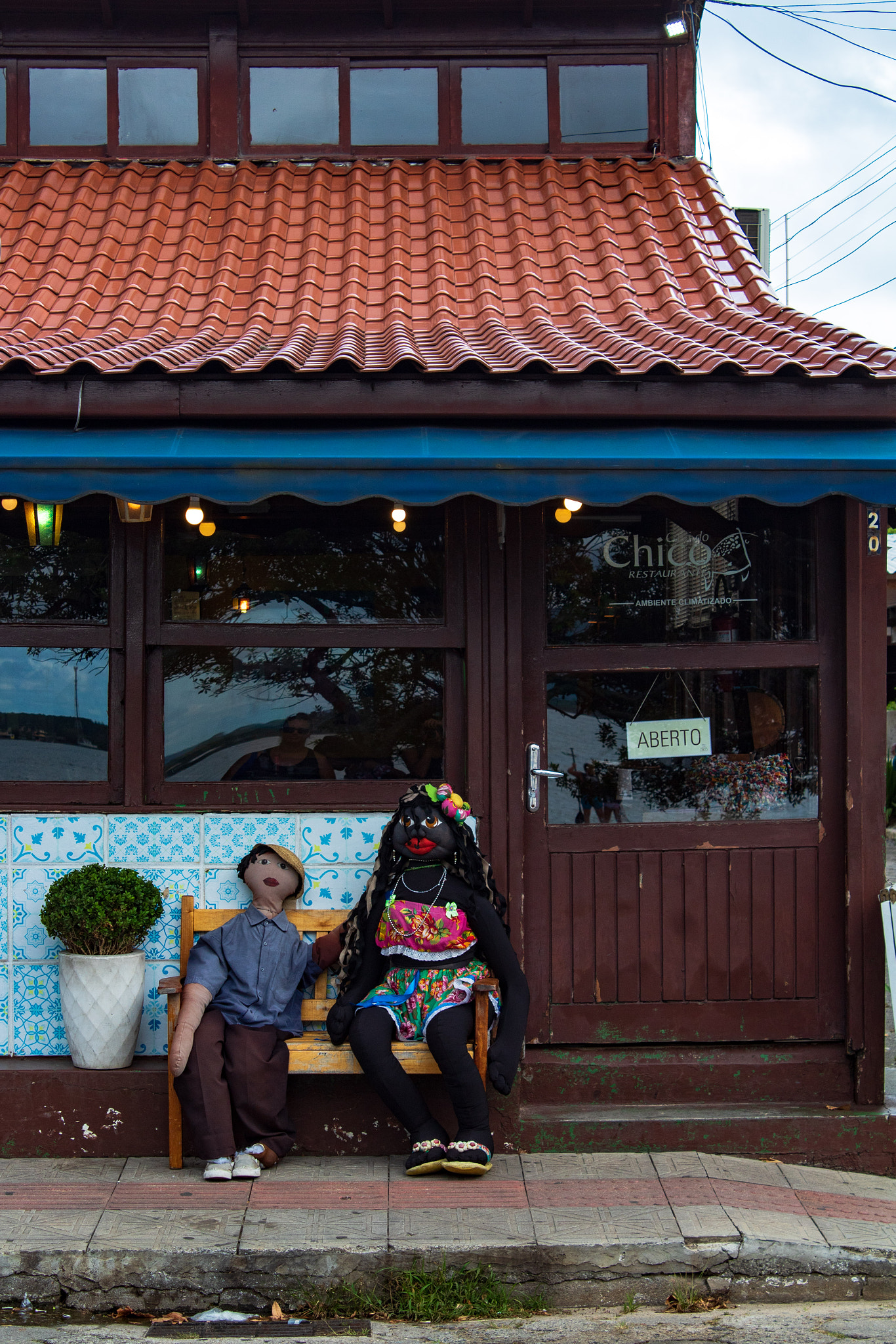 Dolls in front of a restaurant