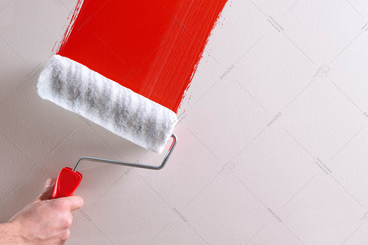 Concept of hand painting red sample on wall