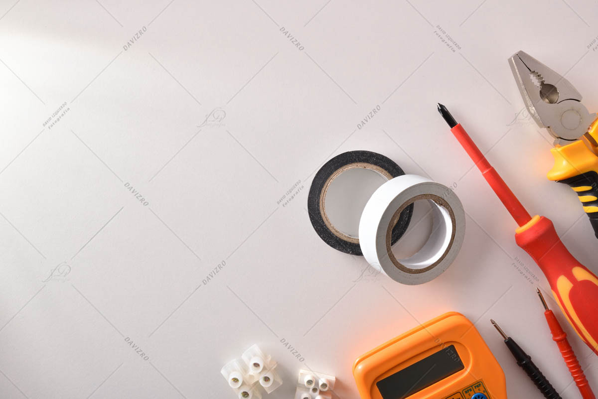 Tools and electrical material on white table space left