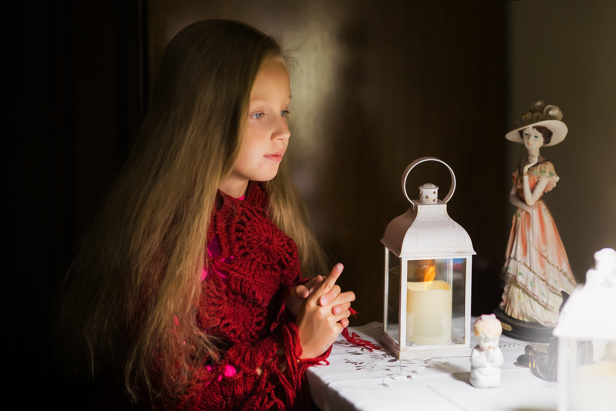 Girl with a candle at home.