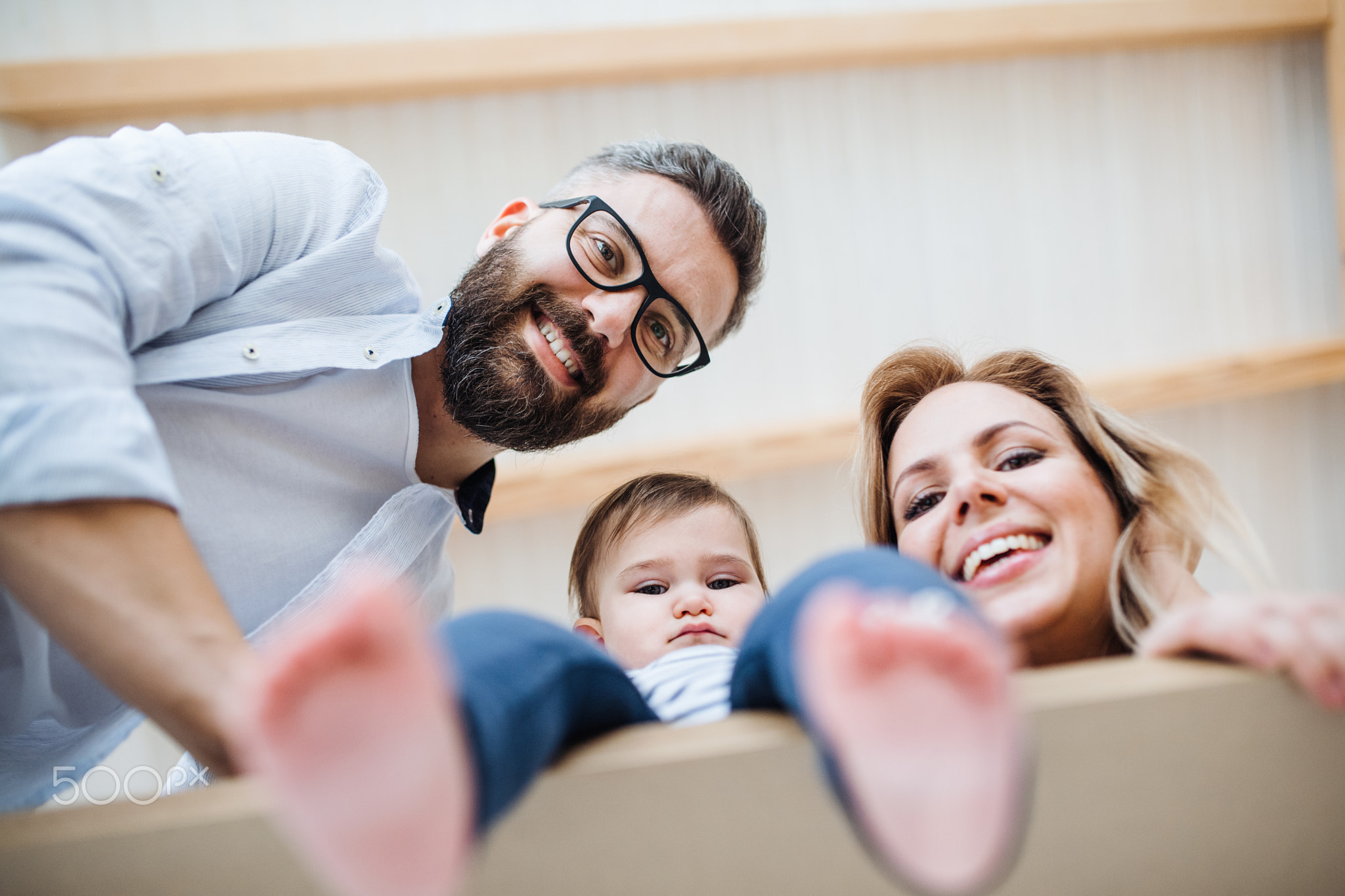 A low-angle view of young family with a toddler girl moving in new home.