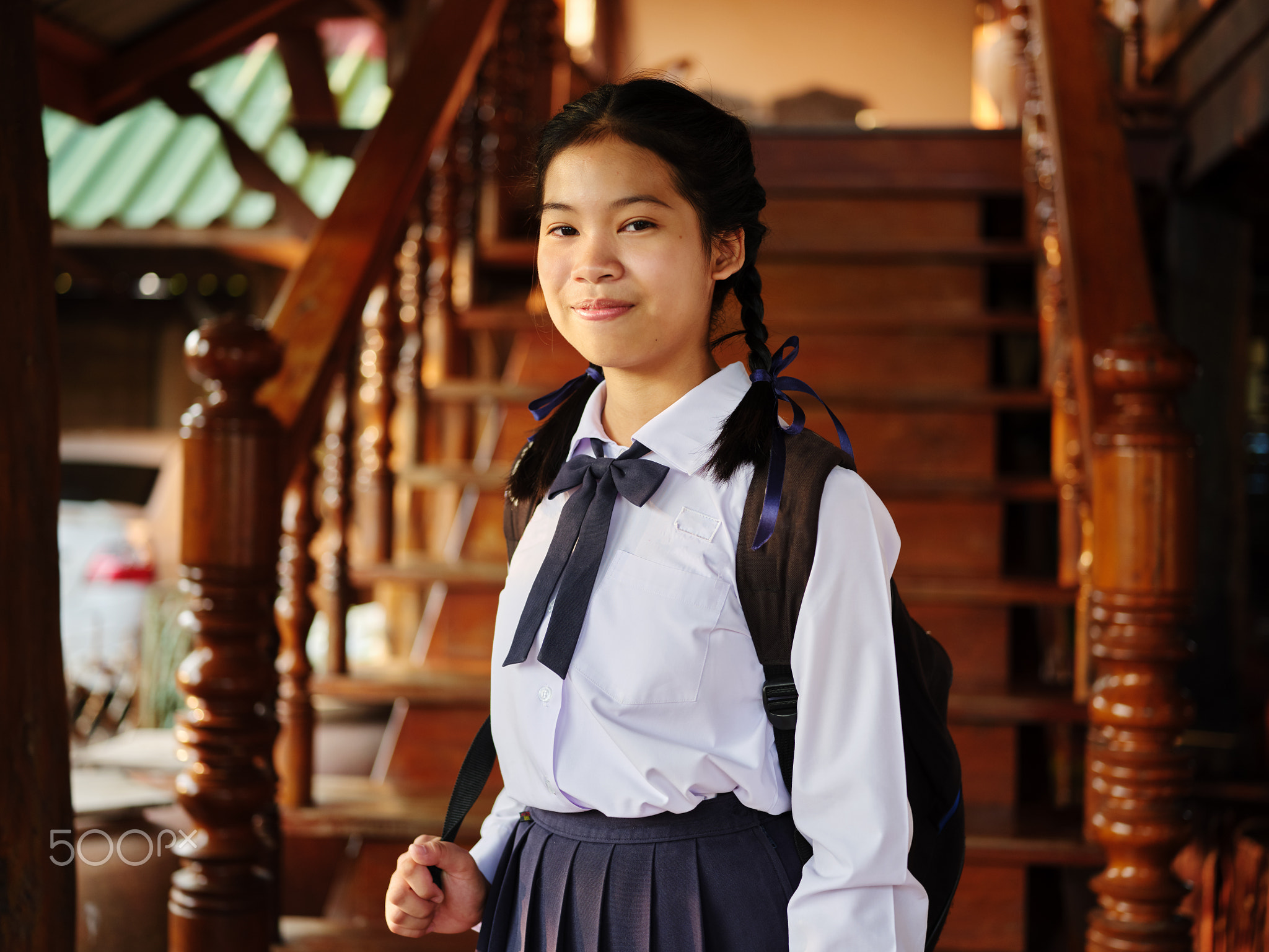 portrait of thai teen in school uniform with backpack ready for school