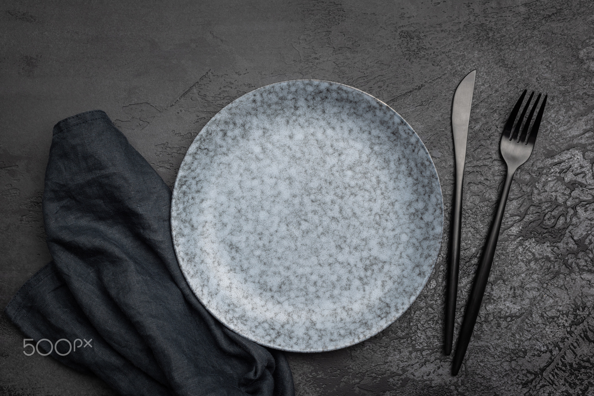 Stylish table setting with black cutlery