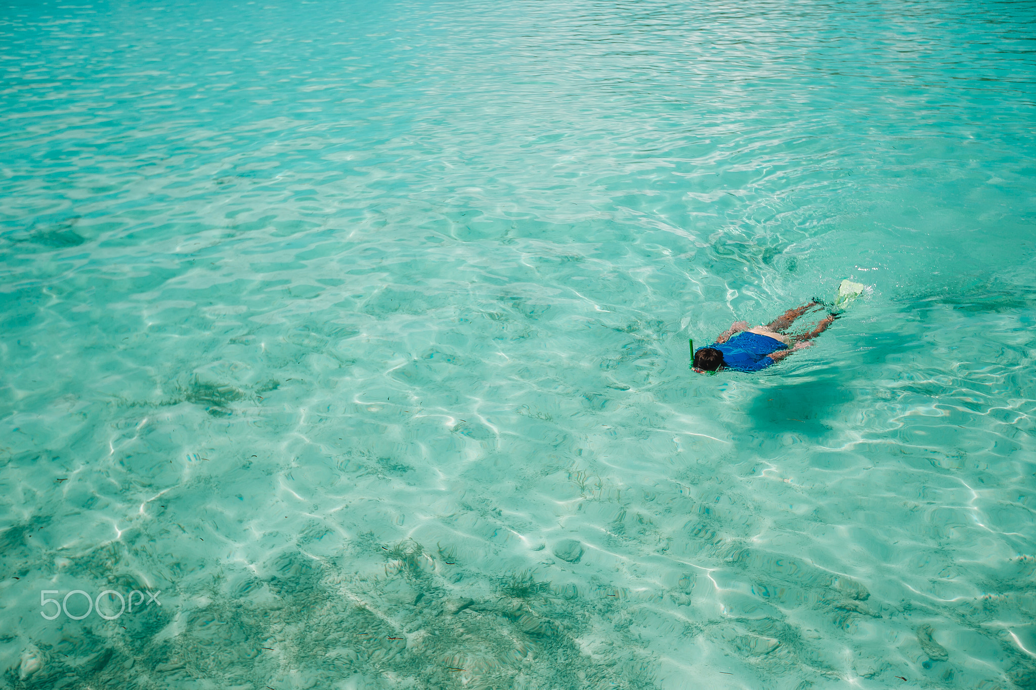 Man swimming in the amazingly turquoise ocean