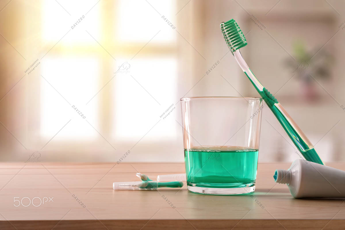 Oral hygiene on wood table in bathroom general composition