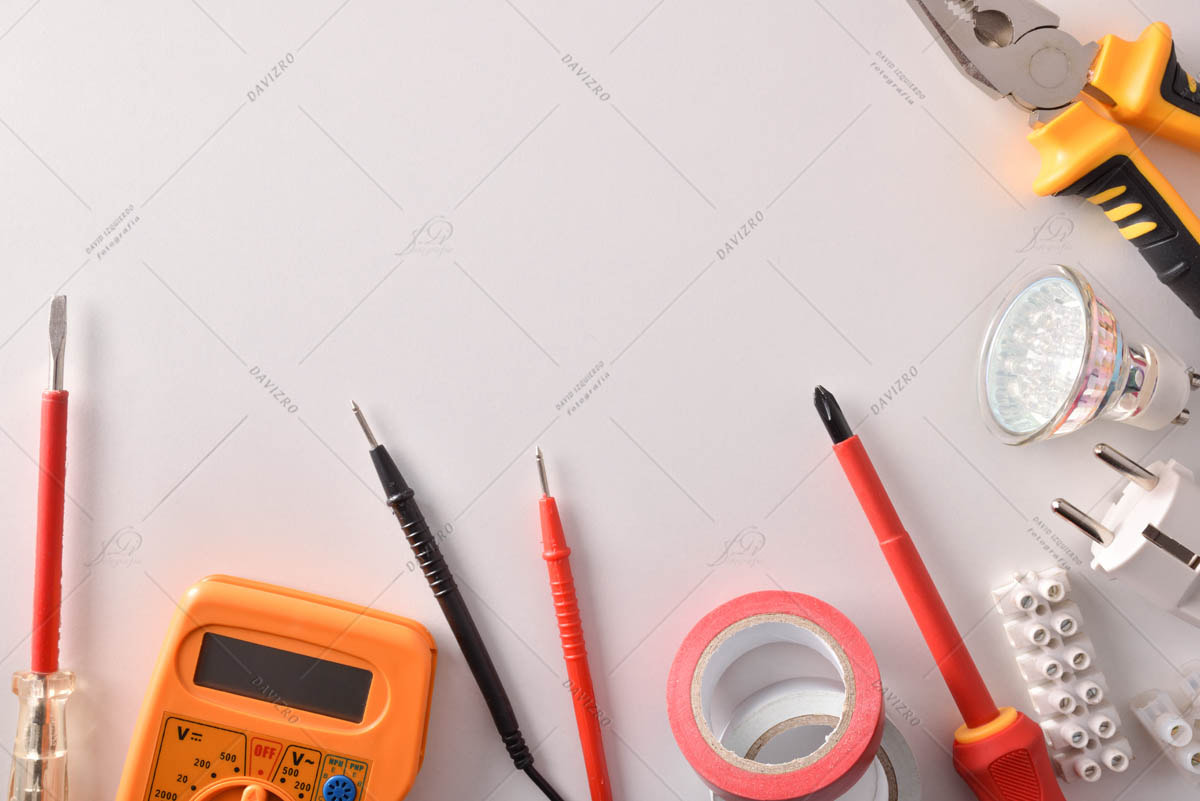 Tools and electrical material on white table space above