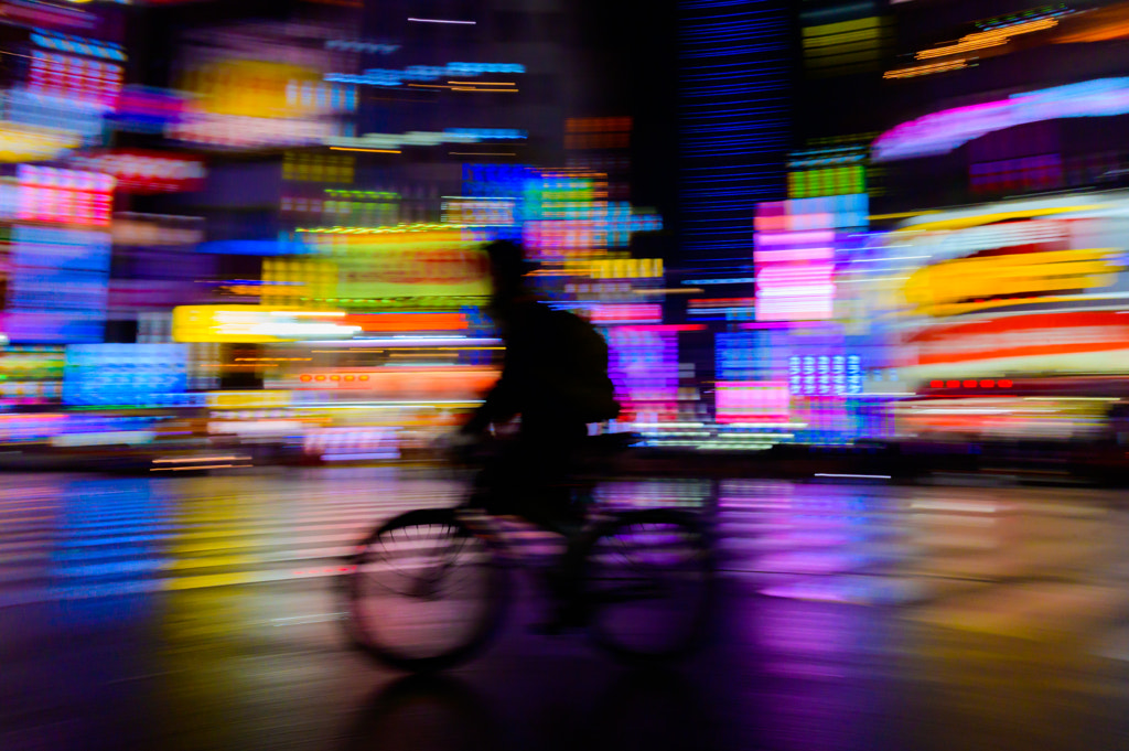 motion blurred of rider ride bicycle with neon light background by WATCHARAPONG THAWORNWICHIAN on 500px.com