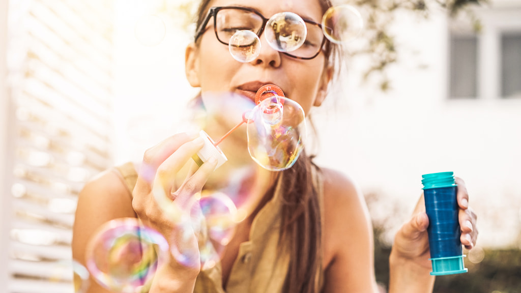 Happy girl blowing soap bubbles outdoor by Alessandro Biascioli on 500px.com